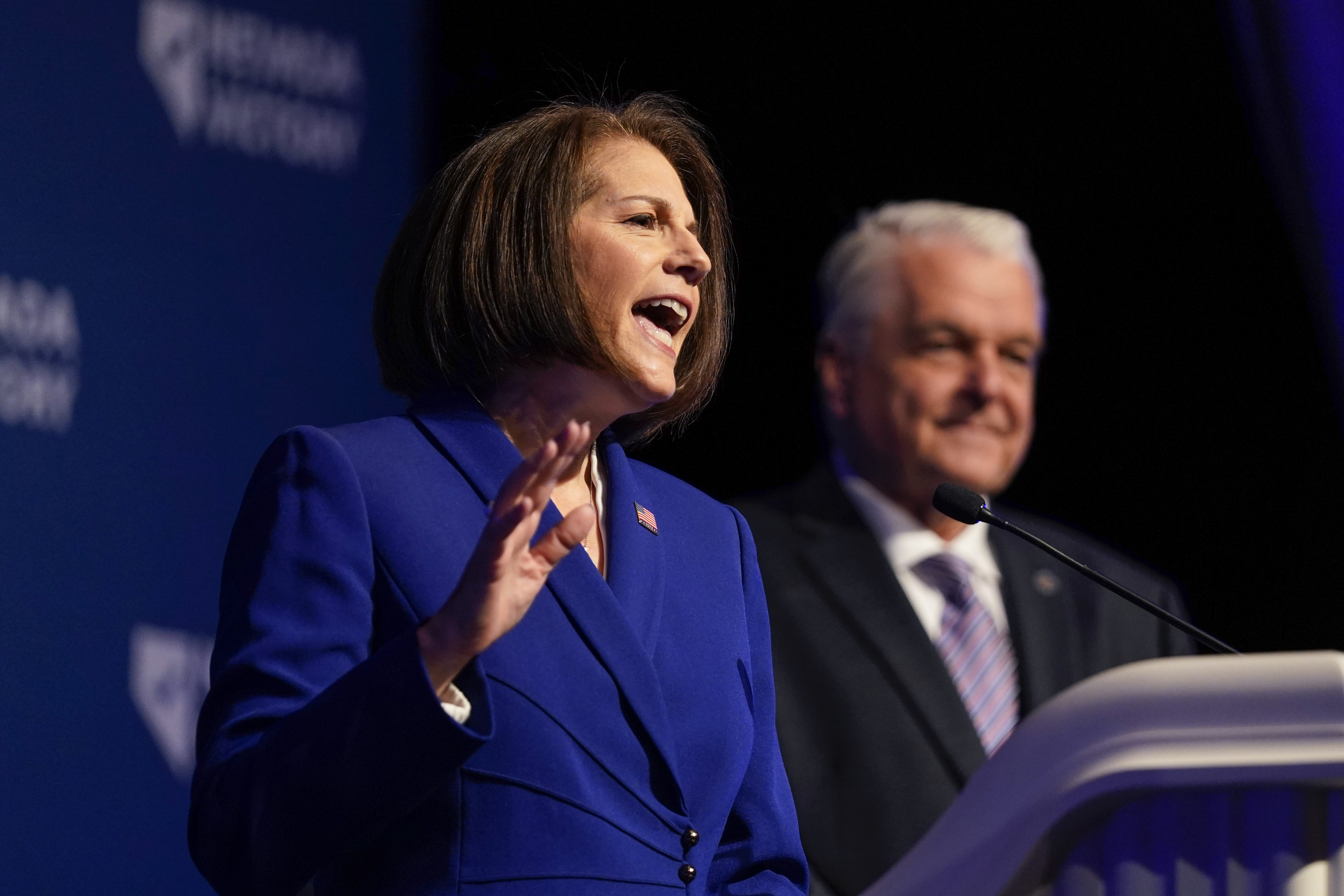 Sen. Catherine Cortez Masto, D-Nev., left, speaks alongside Nevada Gov. Steve Sisolak during an election night party hosted by the Nevada Democratic Party, Tuesday, Nov. 8, 2022, in Las Vegas. (AP Photo/Gregory Bull)