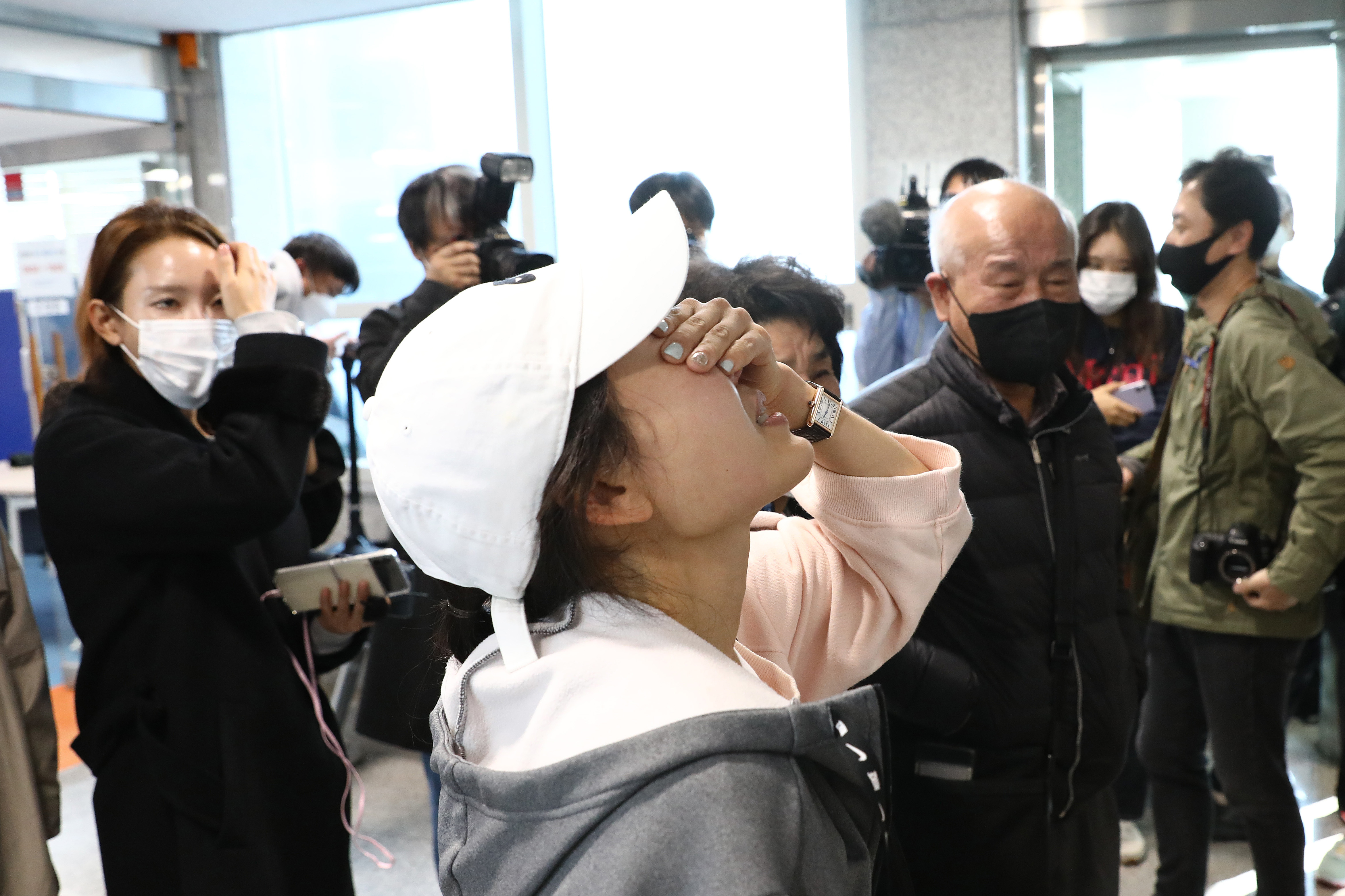 Relatives of missing people weep at a community service centre in Seoul, South Korea.