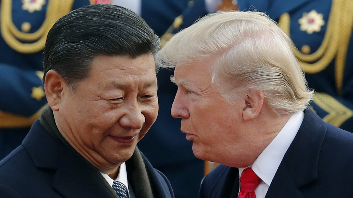 US President Donald Trump chats with Chinese President Xi Jinping during a welcome ceremony at the Great Hall of the People in Beijing. The United States and China are scheduled to resume talks today to try to back off an escalating trade war. 