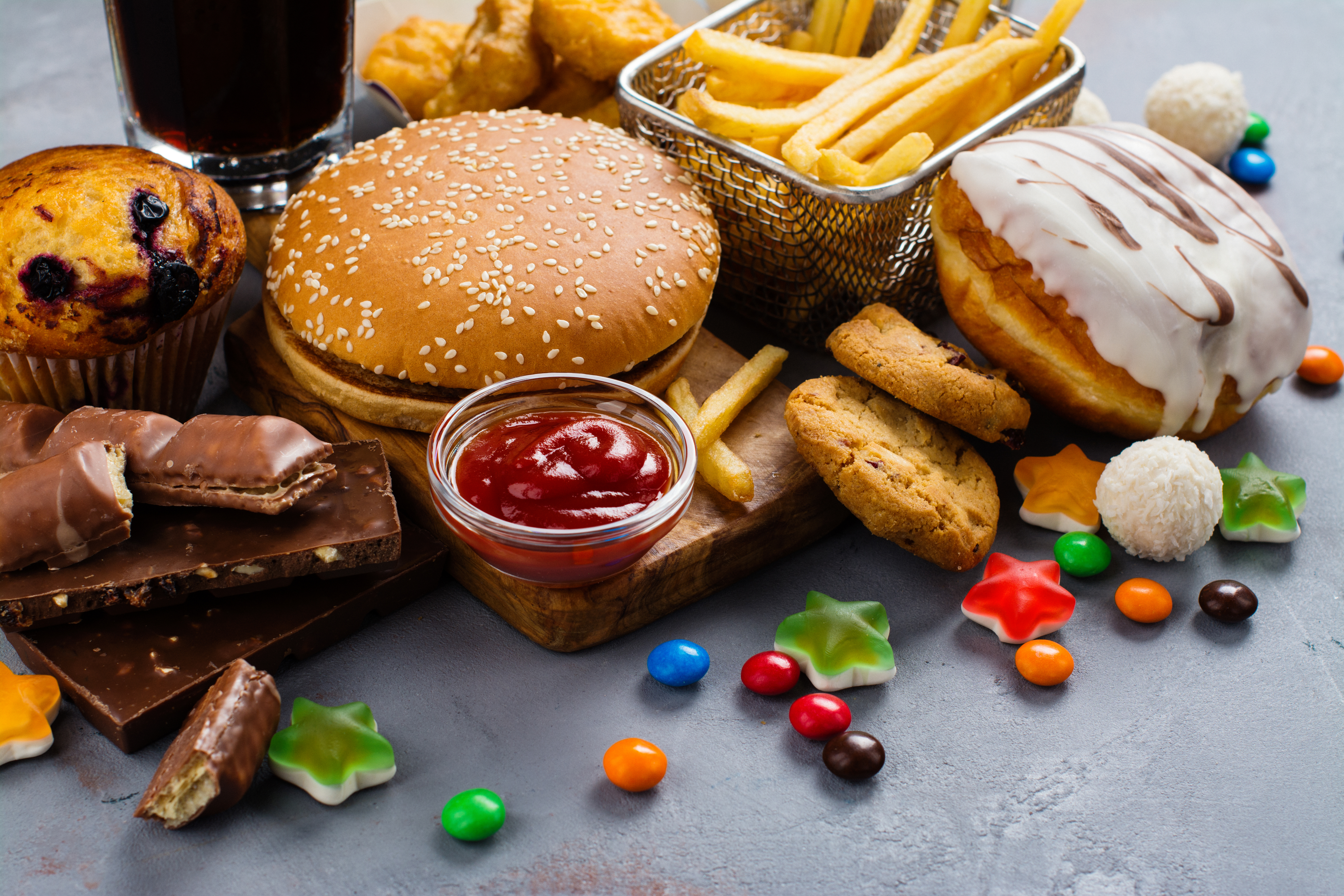 Assortment of unhealthy products that's bad for figure, skin, heart and teeth.