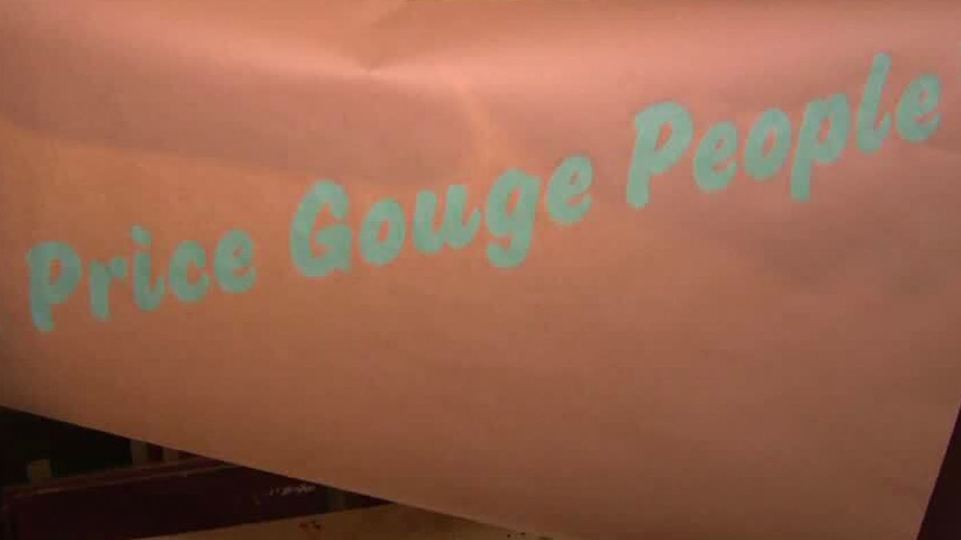 Wearing high-vis, the Bondi-based artist screen printed new slogans.