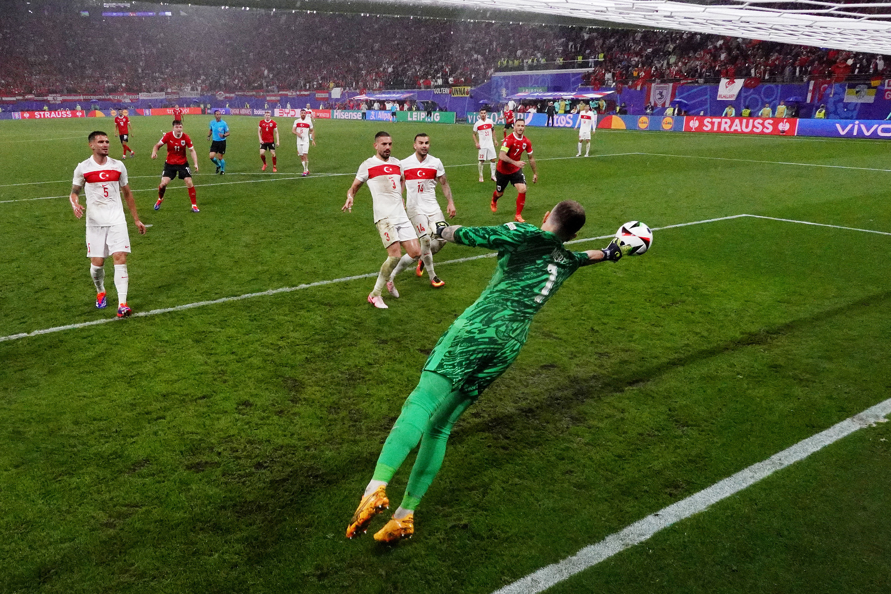 Mert Gunok of Turkiye saves the headed shot of Christoph Baumgartner of Austria (not pictured) during the UEFA EURO round of 16 match between Austria and Turkiye at Football Stadium Leipzig.