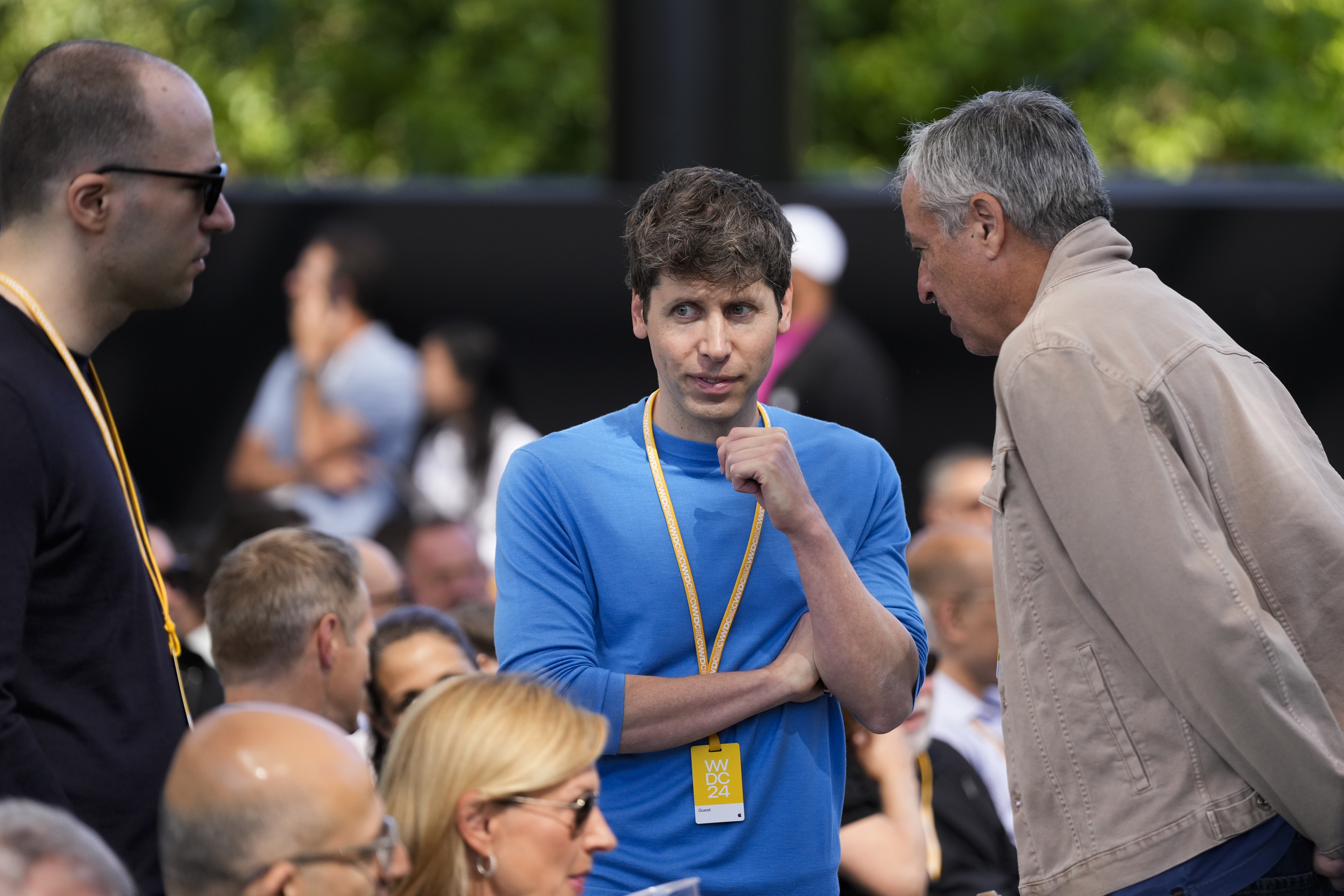 OpenAI CEO Sam Altman, centre, attends the Apple event in Cupertino.