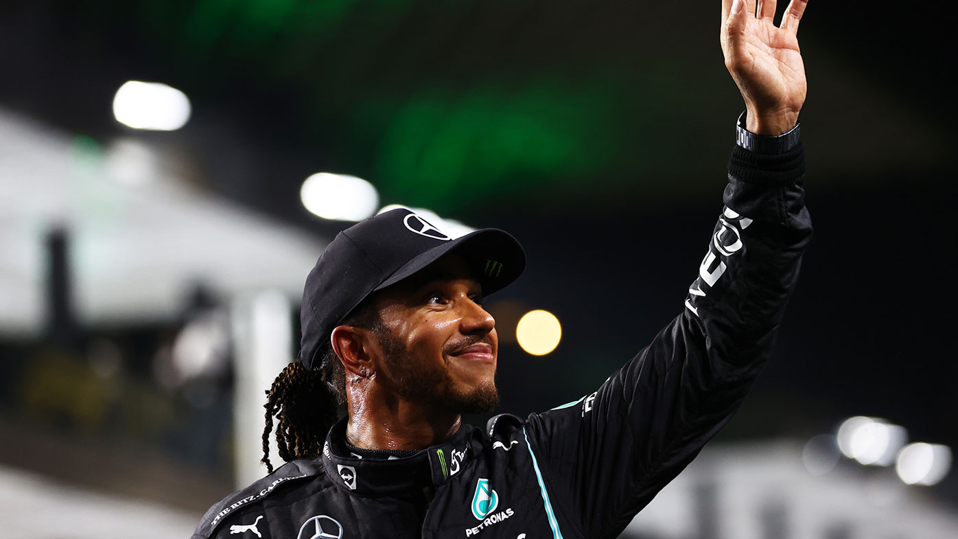Pole position qualifier Lewis Hamilton of Great Britain and Mercedes GP celebrates in parc ferme 