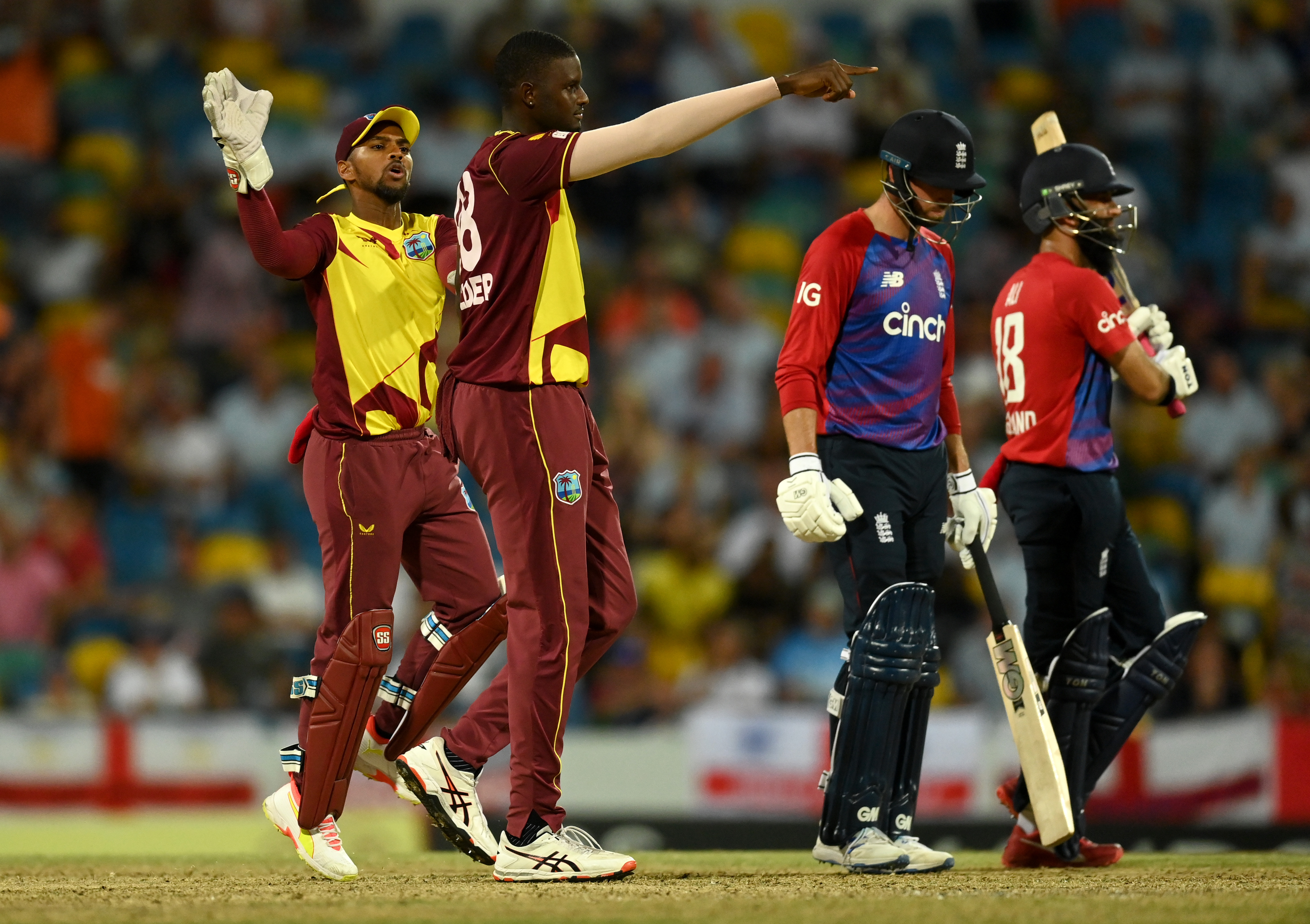 Jason Holder of the West Indies celebrates dismissing England captain Moeen Ali.
