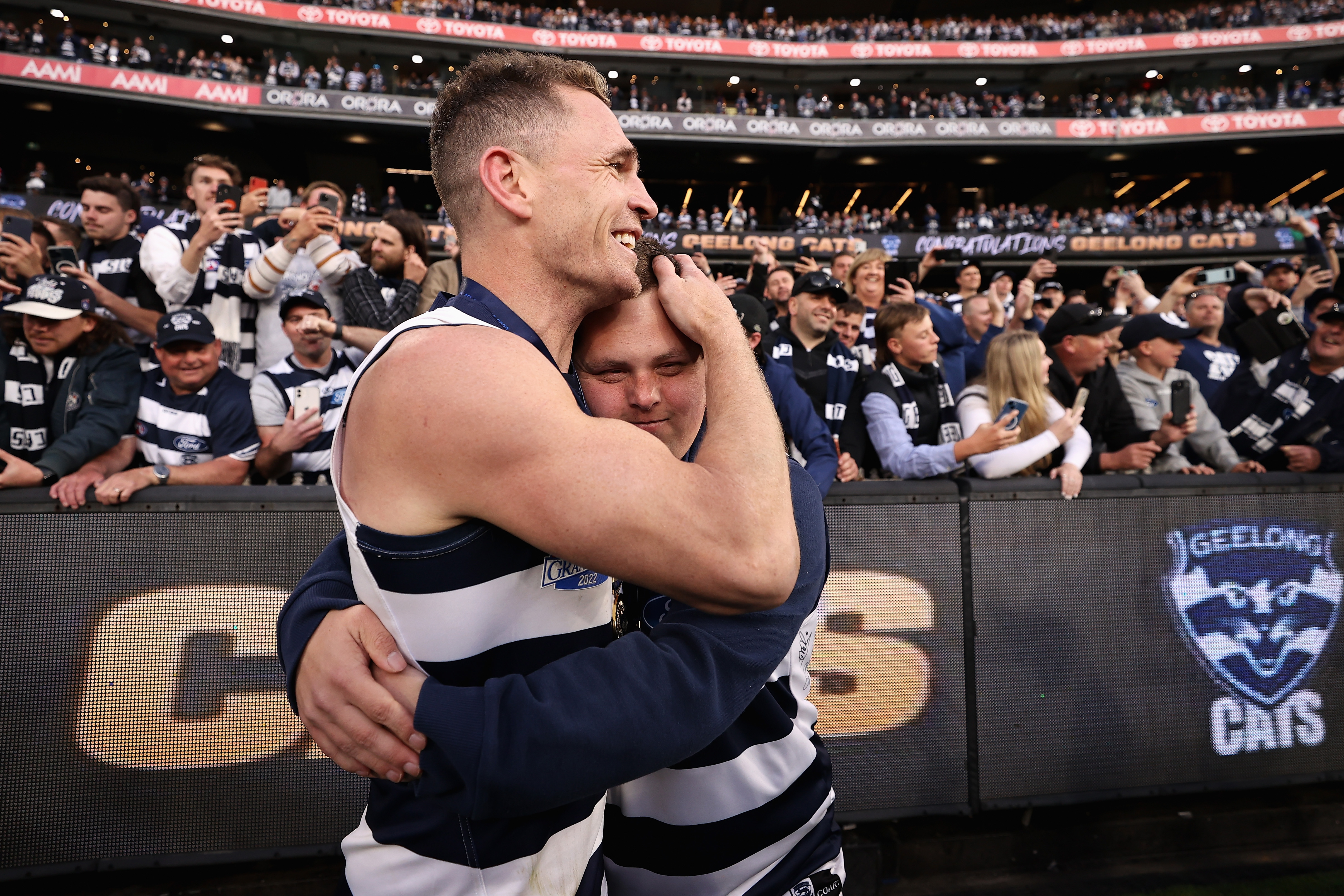 Joel Selwood of the Cats celebrates with Cats head waterboy Sam Moorfoot after winning the 2022 AFL Grand Final match between the Geelong Cats and the Sydney Swans at the Melbourne Cricket Ground on September 24, 2022 in Melbourne, Australia. (Photo by Cameron Spencer/AFL Photos/via Getty Images)