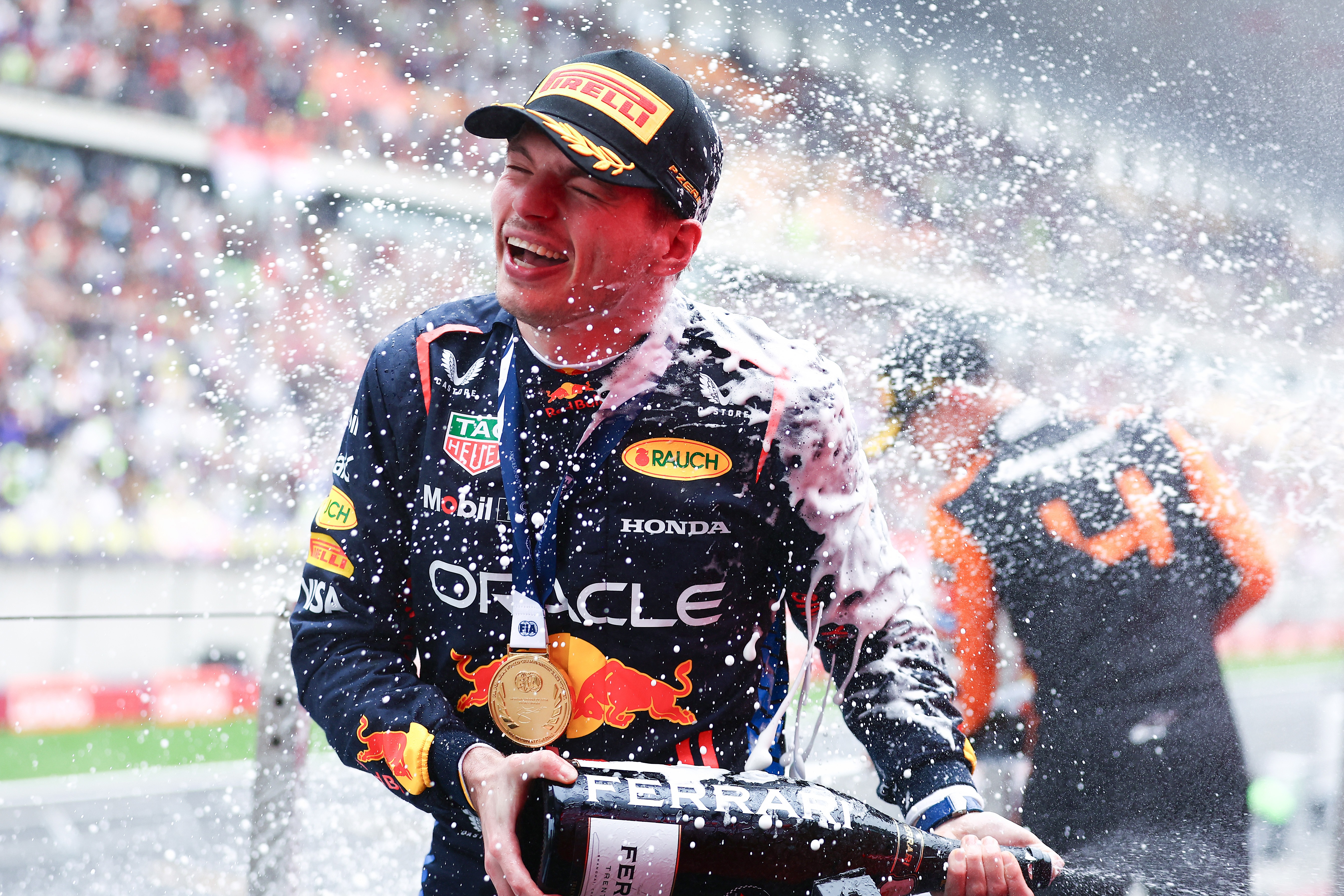 Race winner Max Verstappen celebrates on the podium after the Chinese Grand Prix.