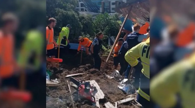 Emergency services work at slip at Mt Maunganui campground where several people are unaccounted for. Photo: Jess Pedersen