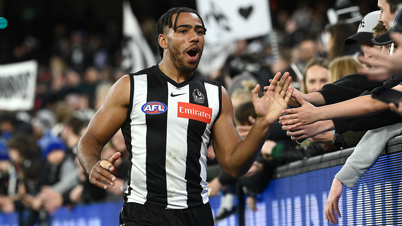 Collingwood defender Isaac Quaynor celebrates with fans