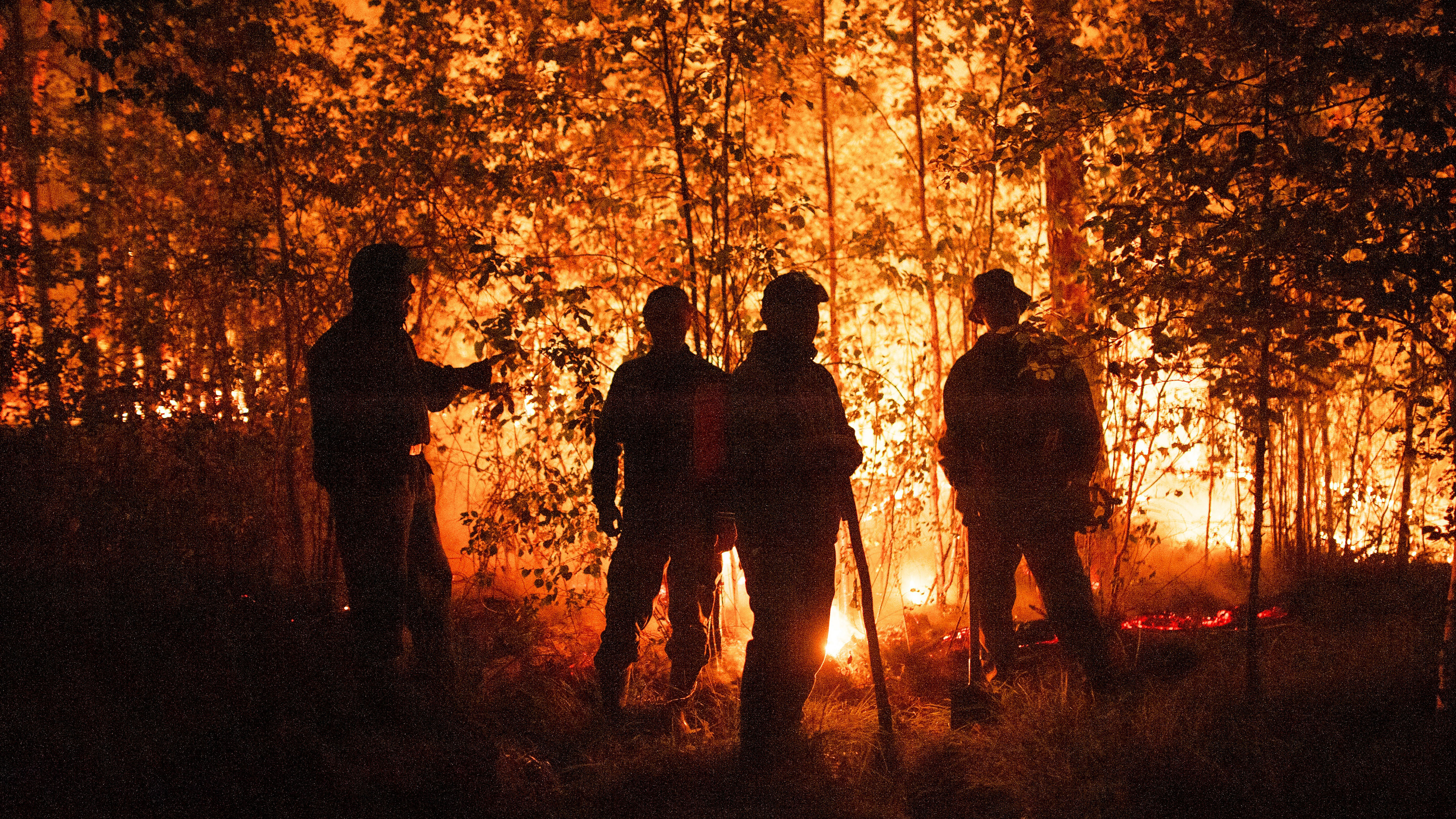 Firefighters work at the scene of forest fire near Kyuyorelyakh village at Gorny Ulus area, west of Yakutsk, in Russia.