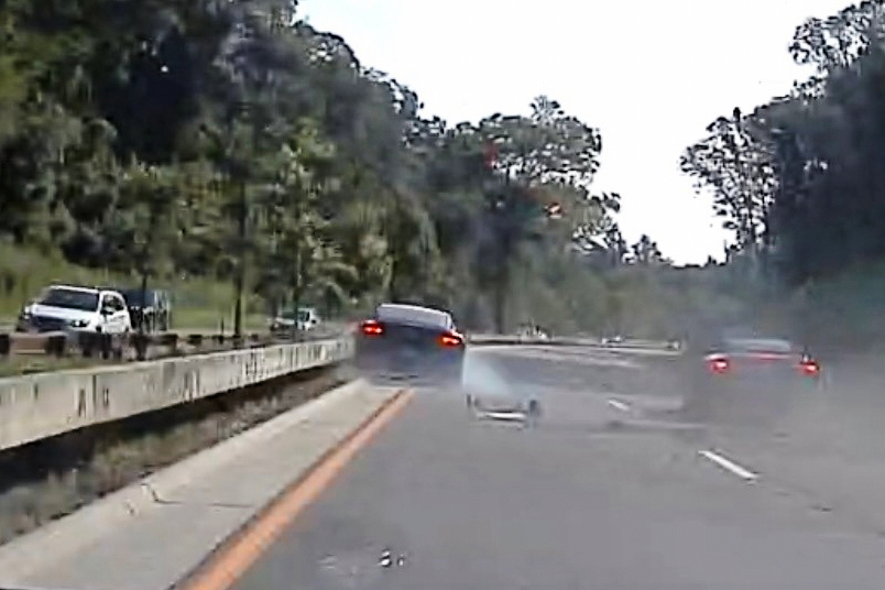 In an image taken from Connecticut State Police police dashcam video, Vince McMahon's car, left, strikes the median after colliding with another car after on July 24, 2025, in Westport, Ct. 