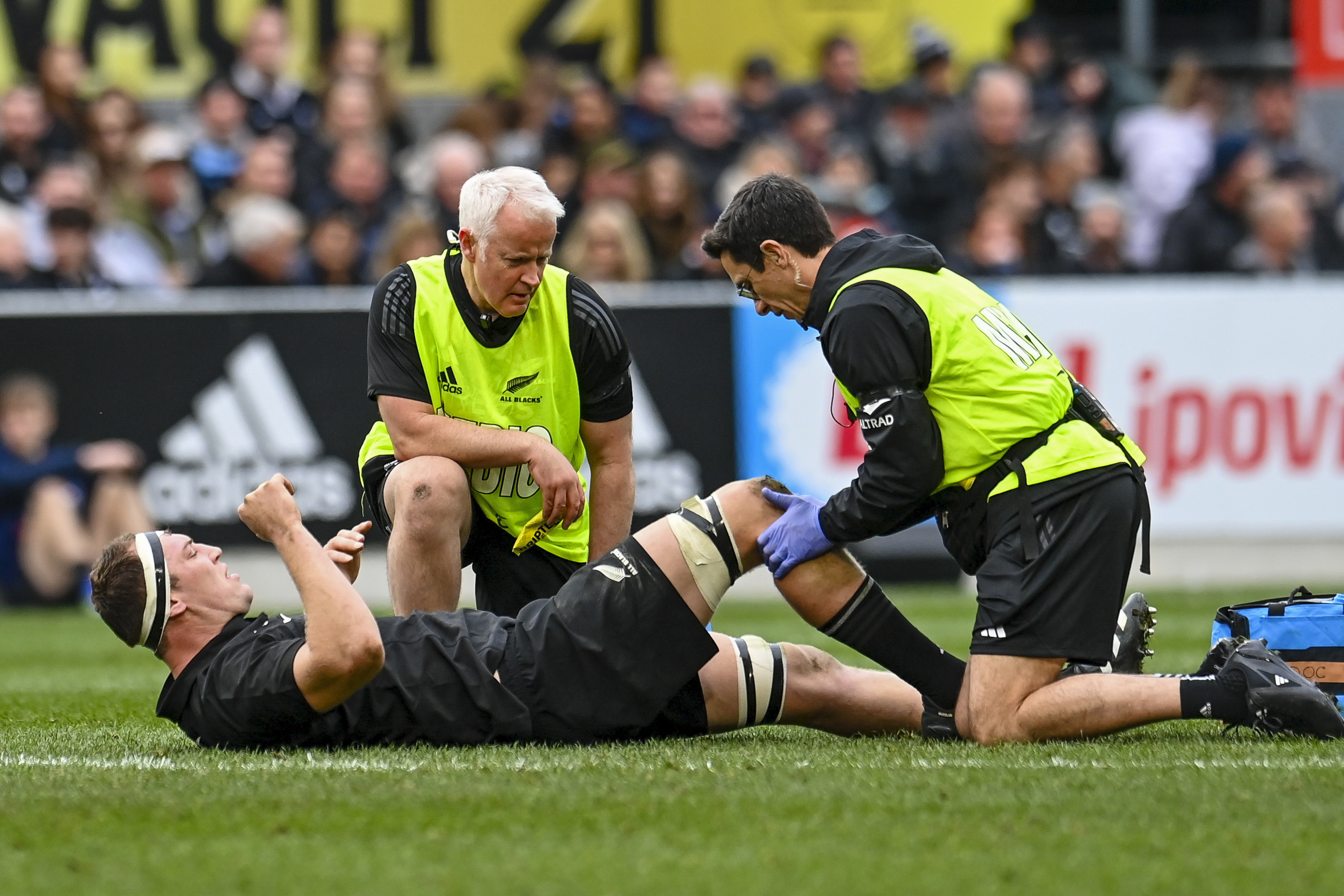 New Zealand's Brodie Retallick receives treatment to a knee injury during the Bledisloe Cup rugby Test match.