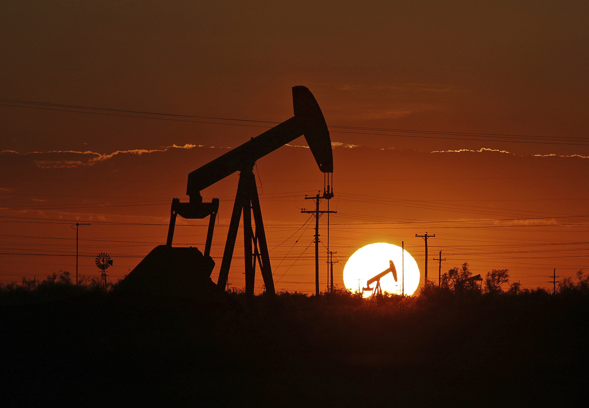 A pump jack operates in an oil field in the Permian Basin in Texas.