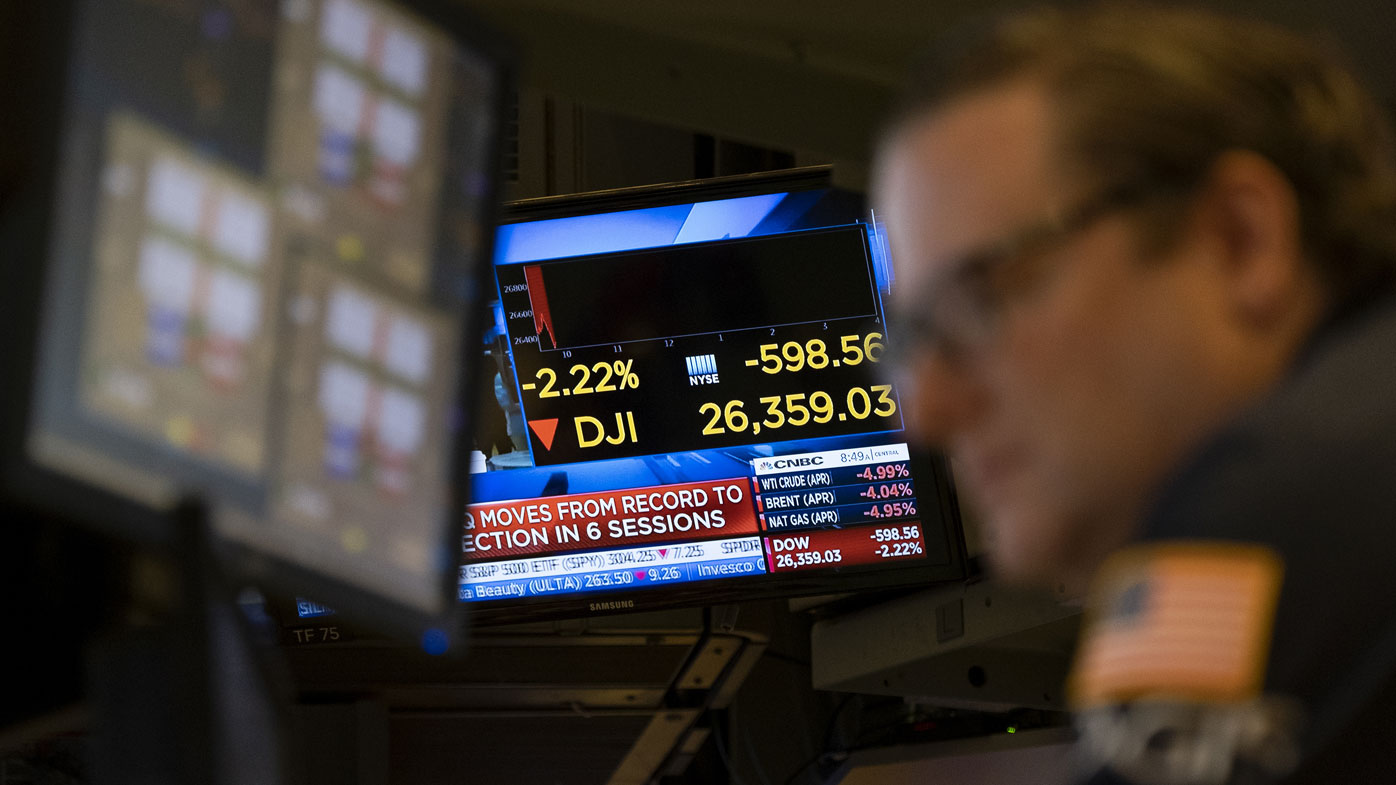 Stocks reflect declines on monitors as people work on the floor of the New York Stock Exchange Thursday, Feb. 27, 2020. 