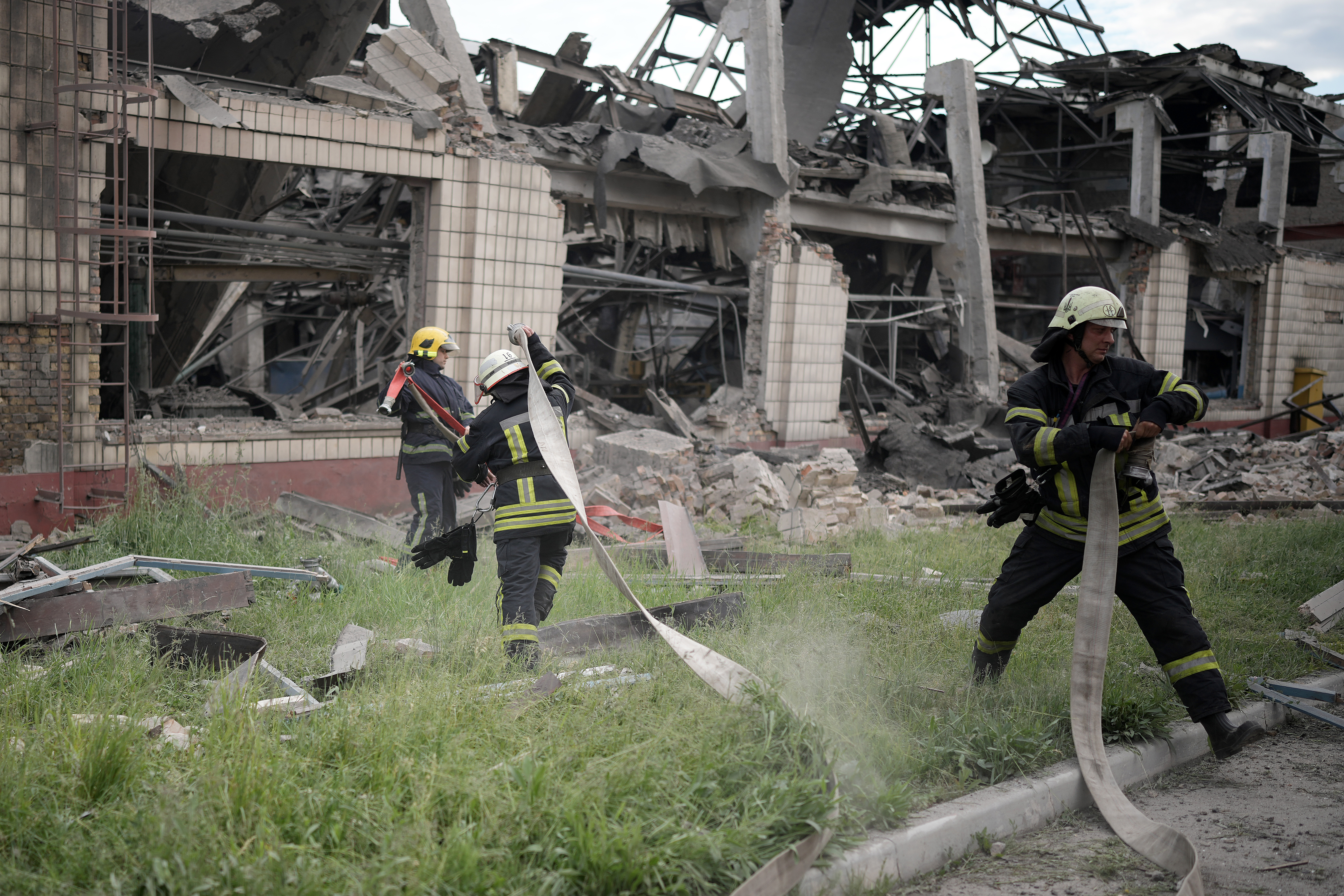 KYIV, UKRAINE - JUNE 05: Firefighters continue to dampen down a rail freight rolling stock repair facility in Darnytsia district after a Russian air strikeon June 05, 2022 in Kyiv, Ukraine. Four Russian air missiles hit the site early this morning with a fifth rocket landing in woodland close by. (Photo by Christopher Furlong/Getty Images)