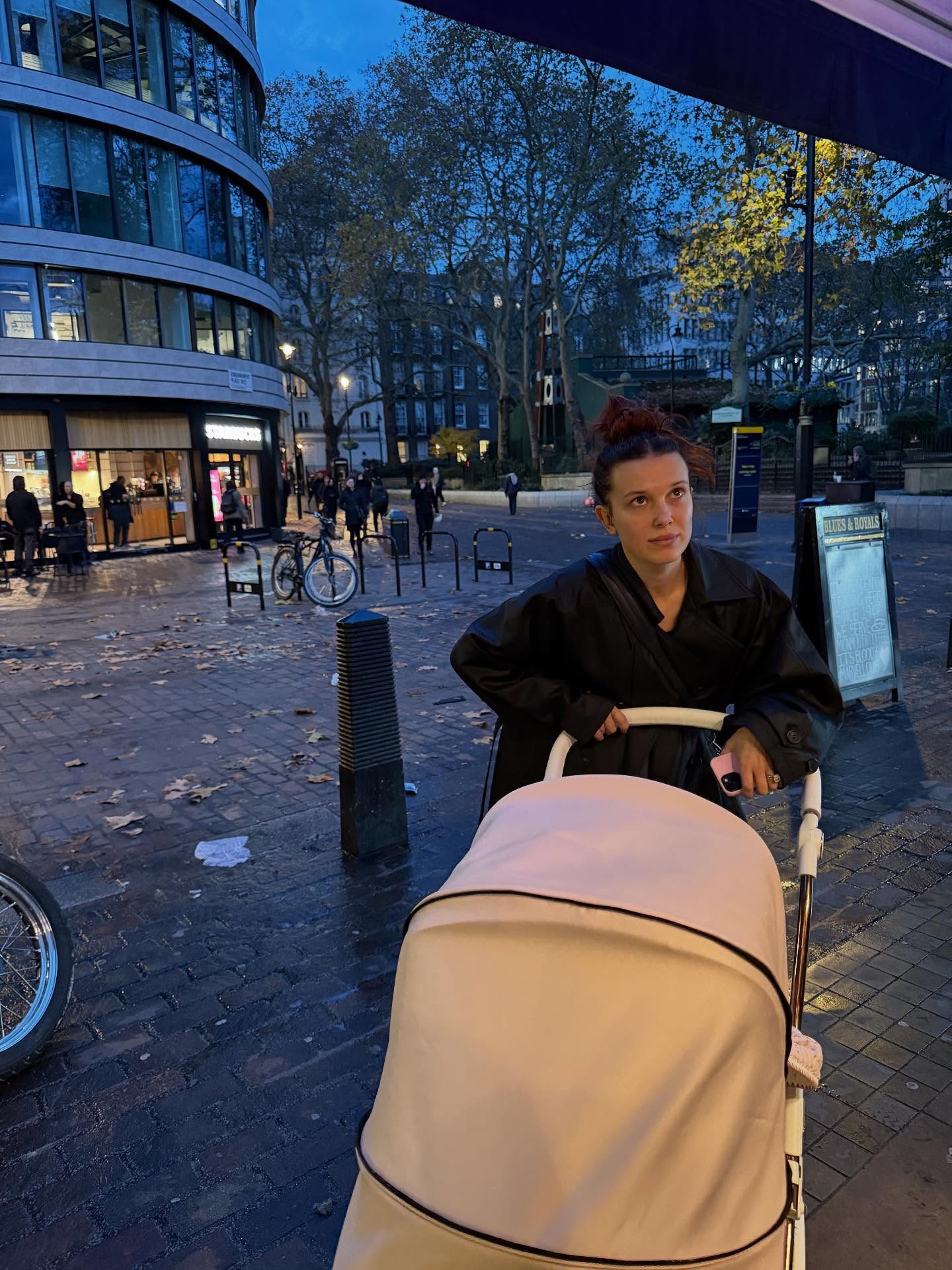 Millie Bobby Brown pushing her daughter in a pram