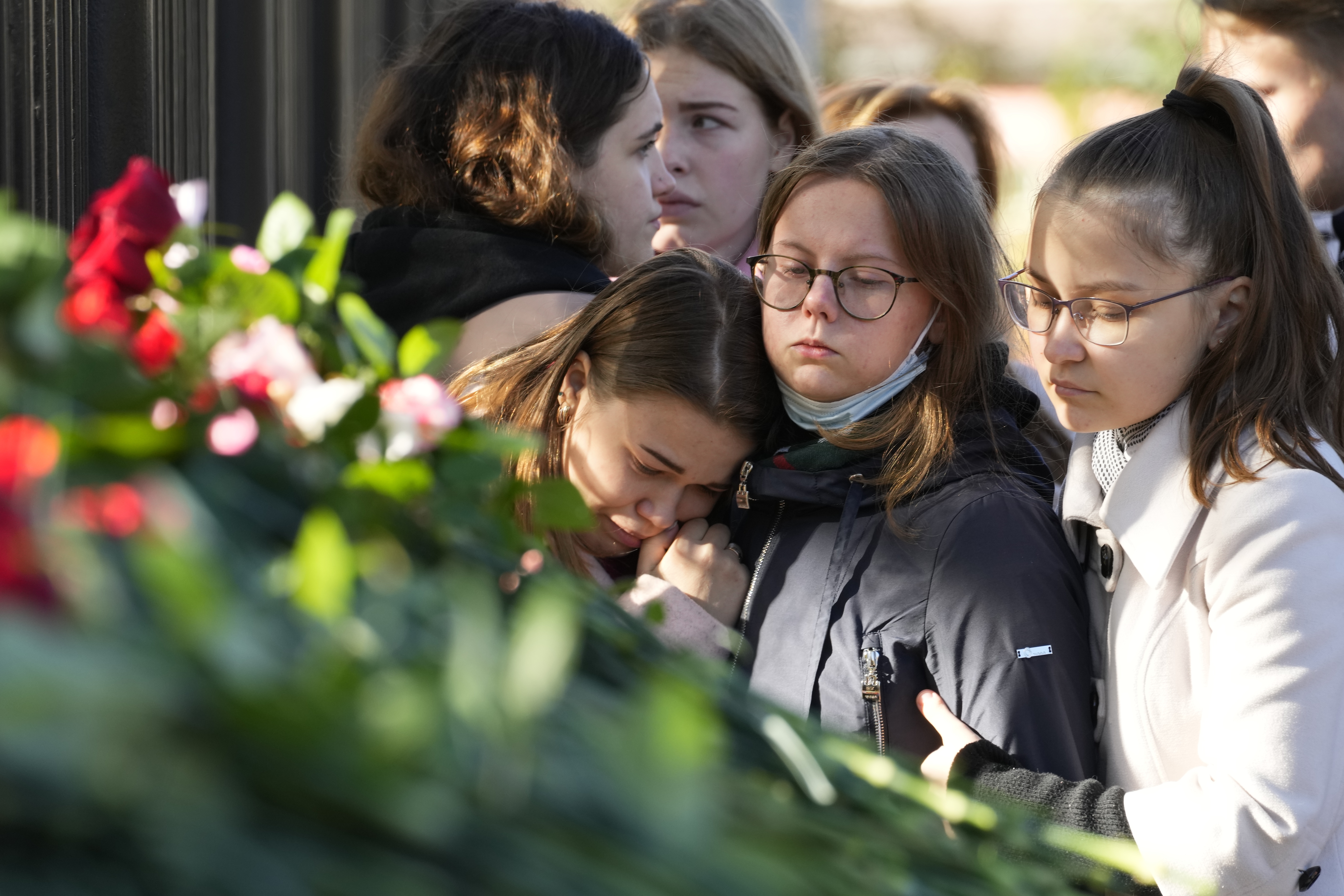 Students comfort each other as they gather outside the Perm State University following the campus shooting. (AP Photo/Dmitri Lovetsky)