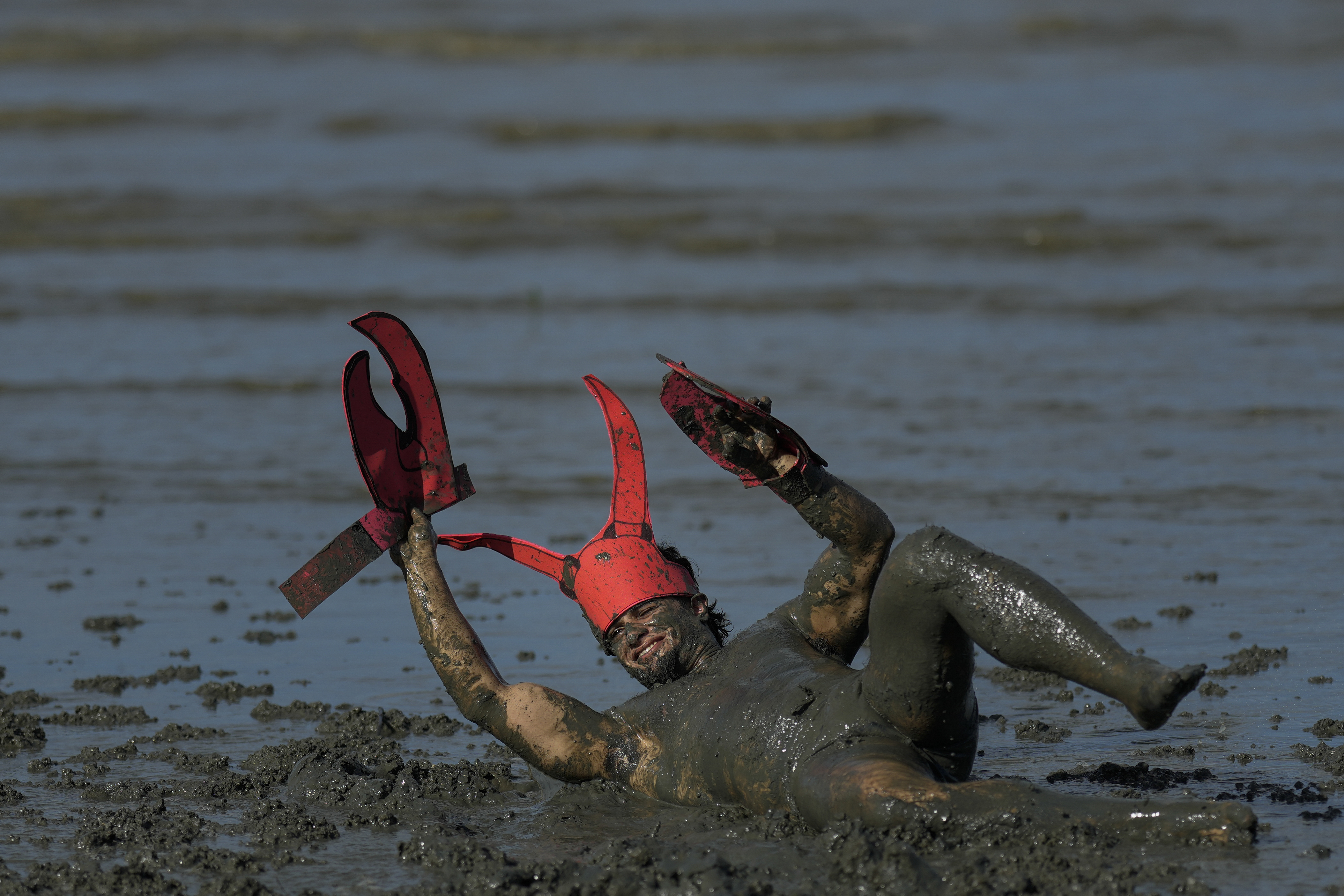 Mud-covered Carnival revellers are a strange sight in sleepy Brazilian town