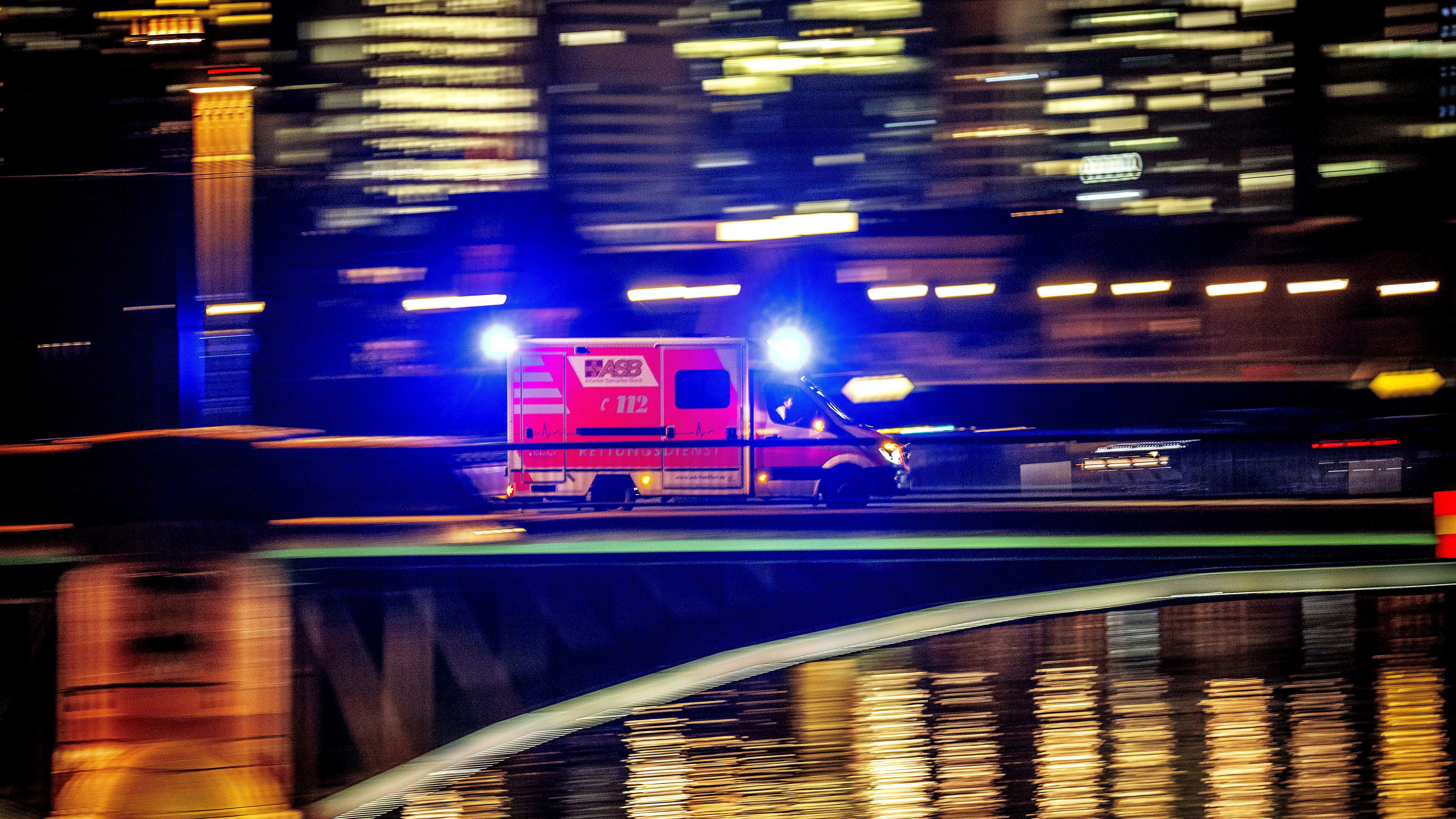 An ambulance speeds over a bridge in Frankfurt, Germany, 
