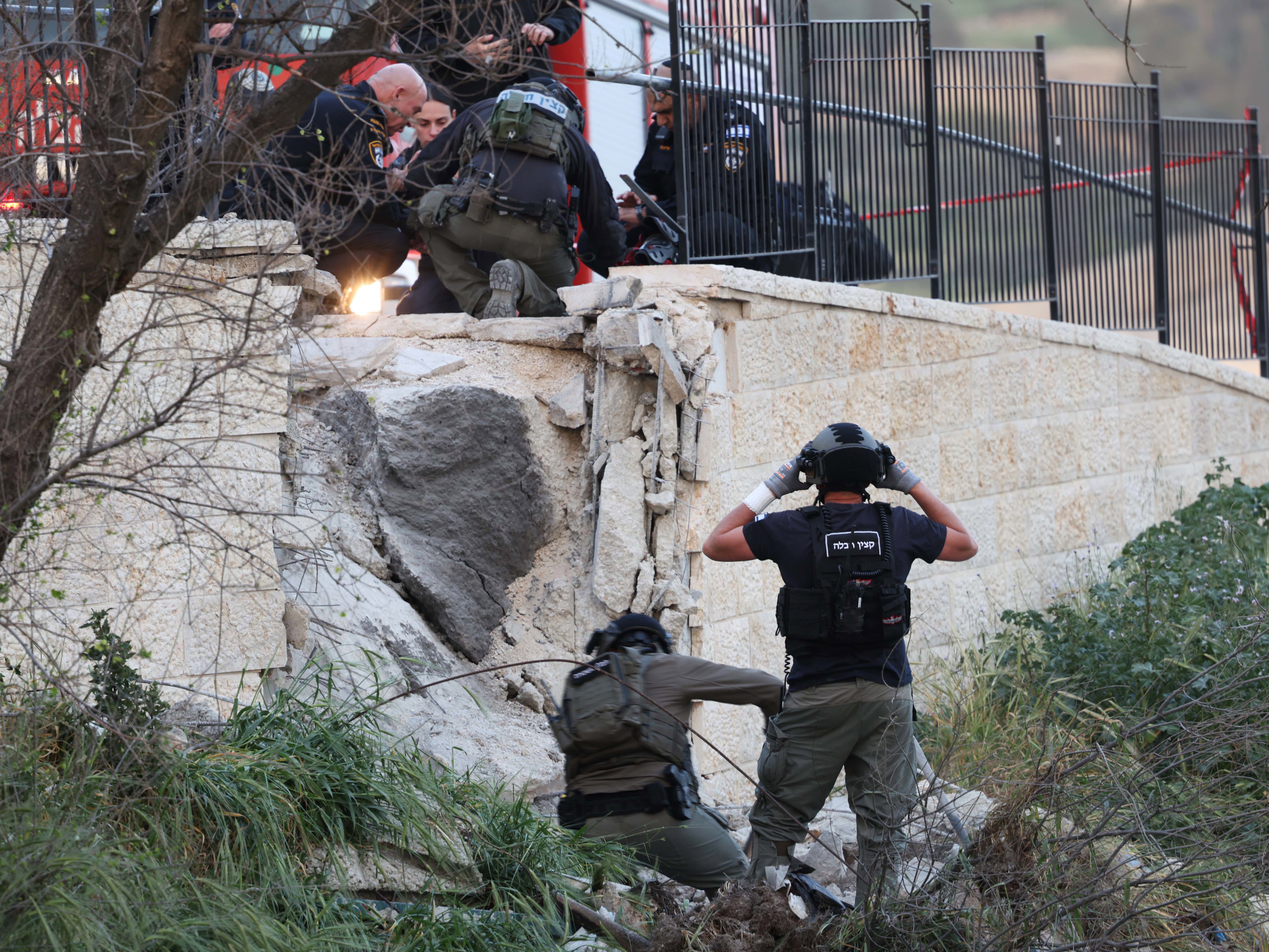 First responders inspect damage where an Iranian missile fragment landed  in the Old City of Jerusalem.