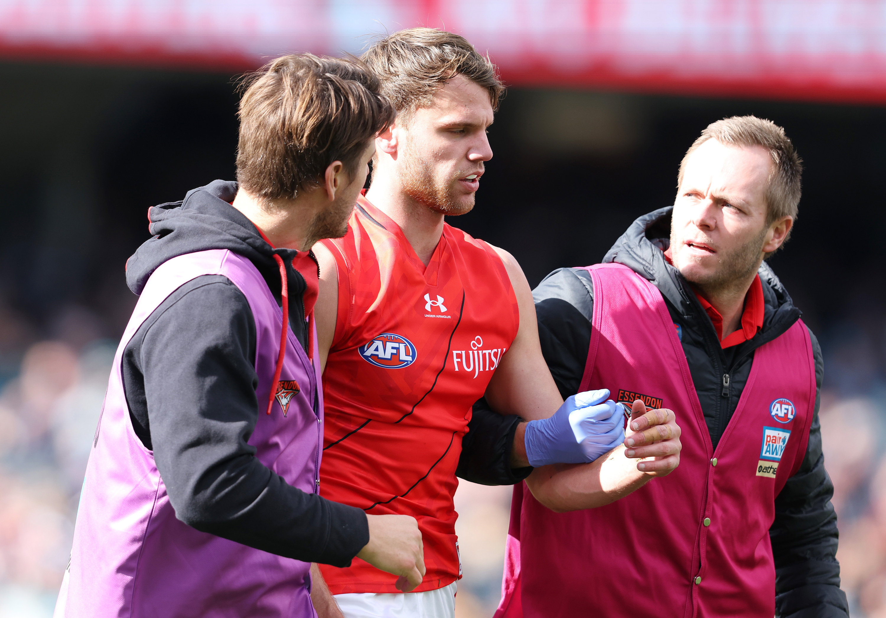 ADELAIDE, AUSTRALIA - MAY 07: Jordan Ridley of the Bombers taken from the ground with possible concussion during the 2023 AFL Round 08 match between the Port Adelaide Power and the Essendon Bombers at Adelaide Oval on May 7, 2023 in Adelaide, Australia. (Photo by Sarah Reed/AFL Photos)