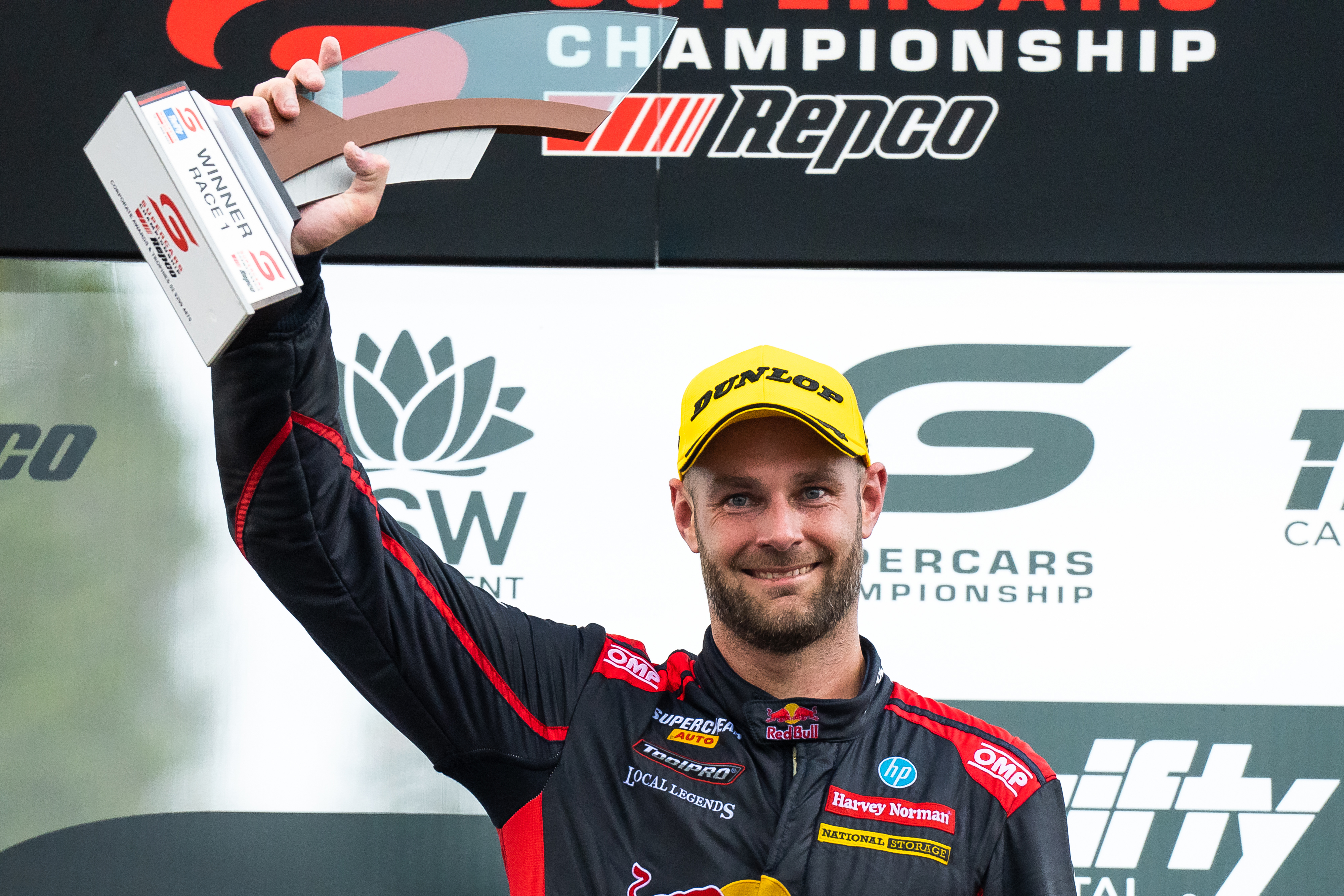 Shane van Gisbergen stands on the podium after his race two win in Newcastle.