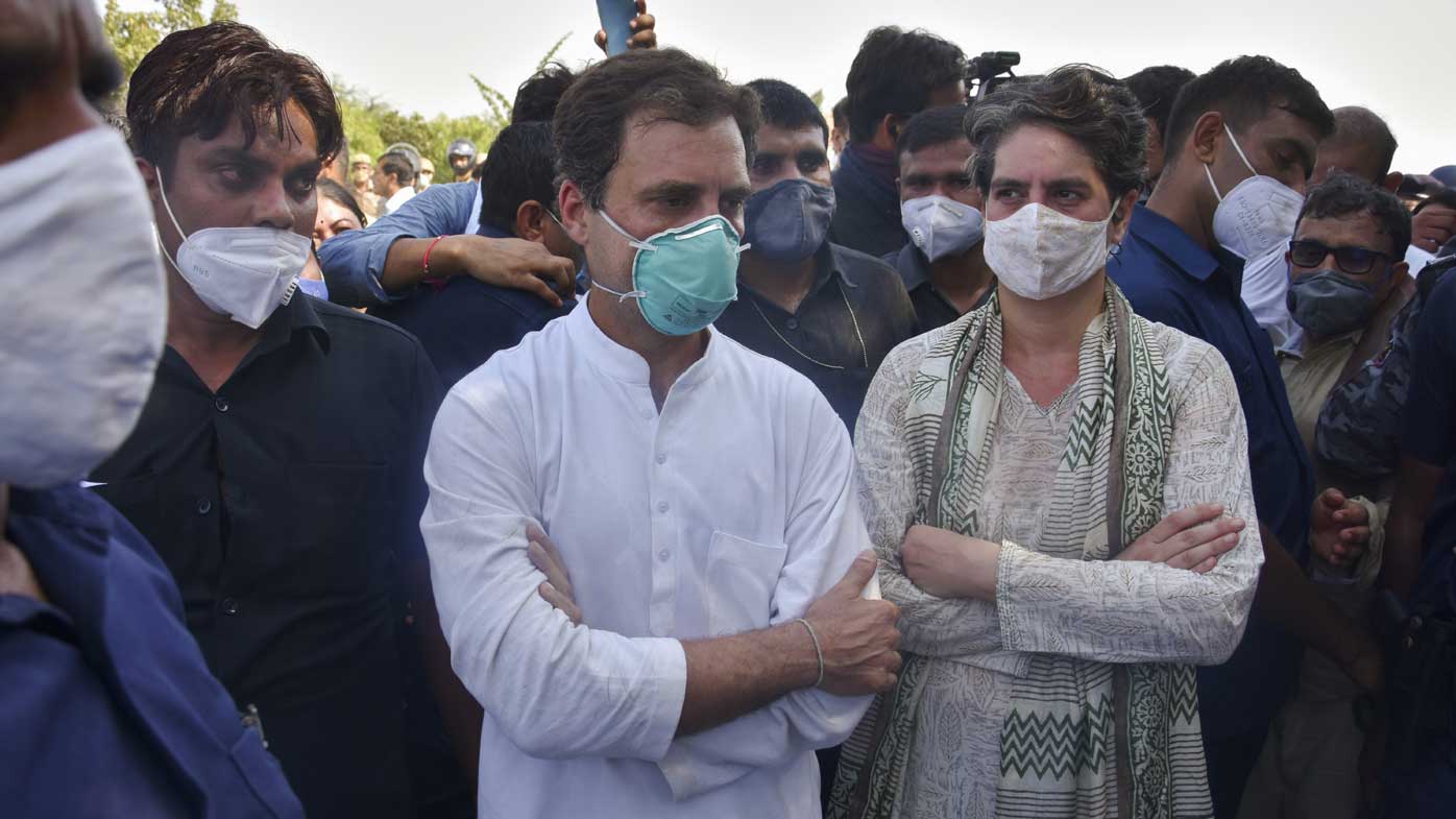 India's opposition Congress party leaders, Rahul Gandhi, center and his sister Priyanka Gandhi stand after they are stopped by police on a highway in Gautam Buddha Nagar, Uttar Pradesh.