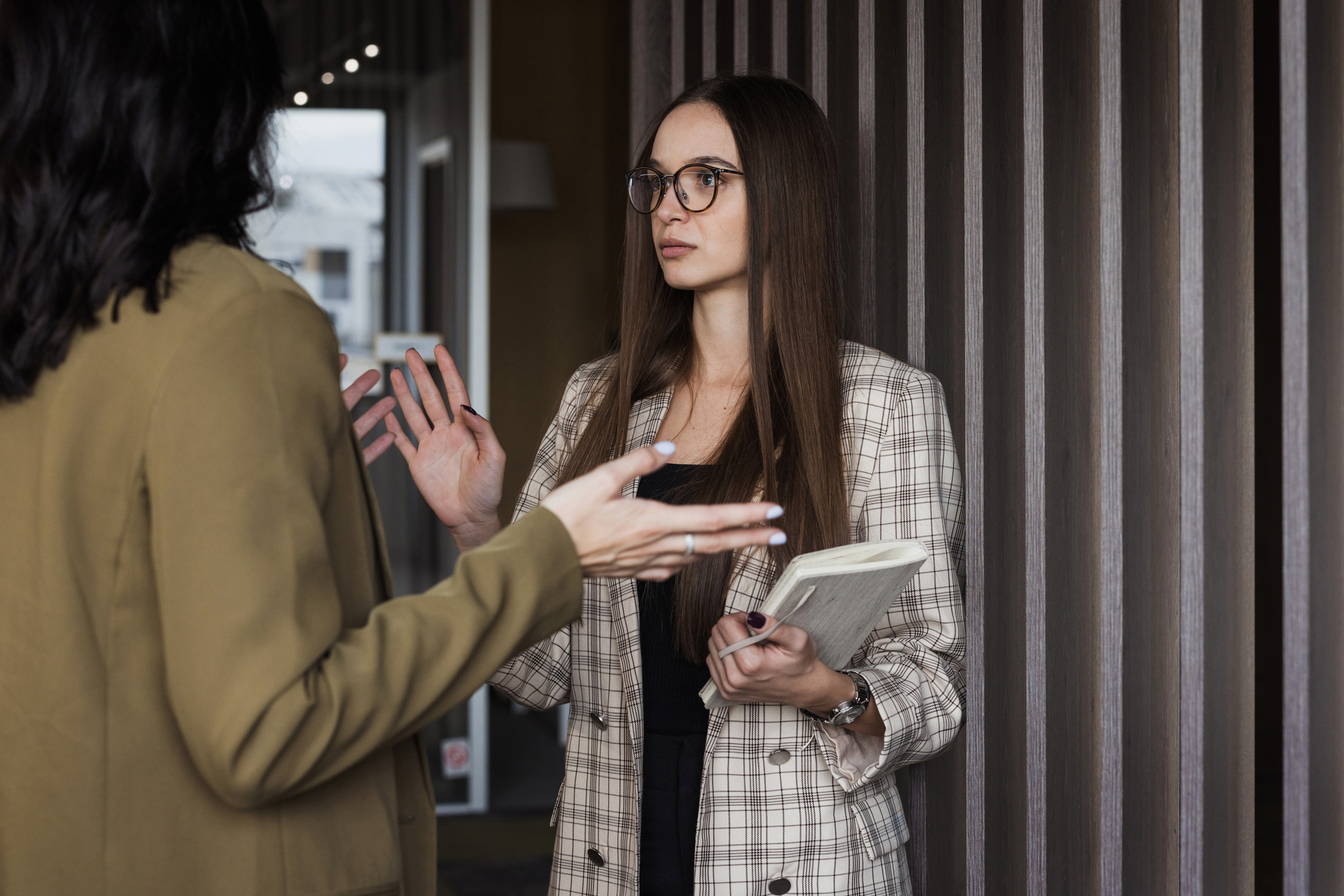 Angry and irritated businesswoman arguing with a coworker