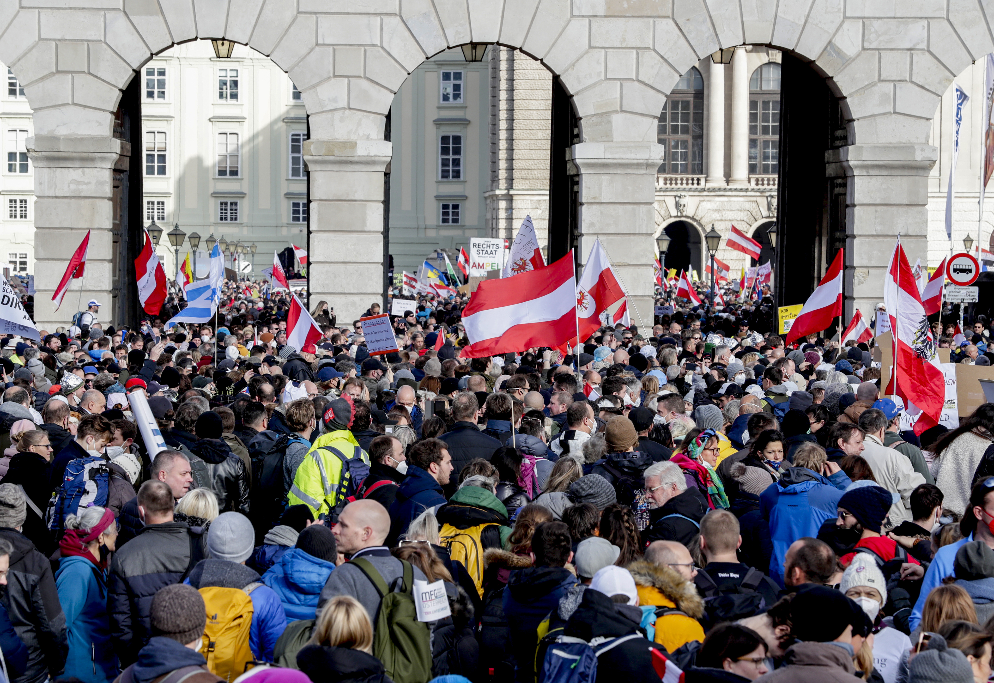 People take part in a demonstration against the country's coronavirus restrictions in Vienna, Austria