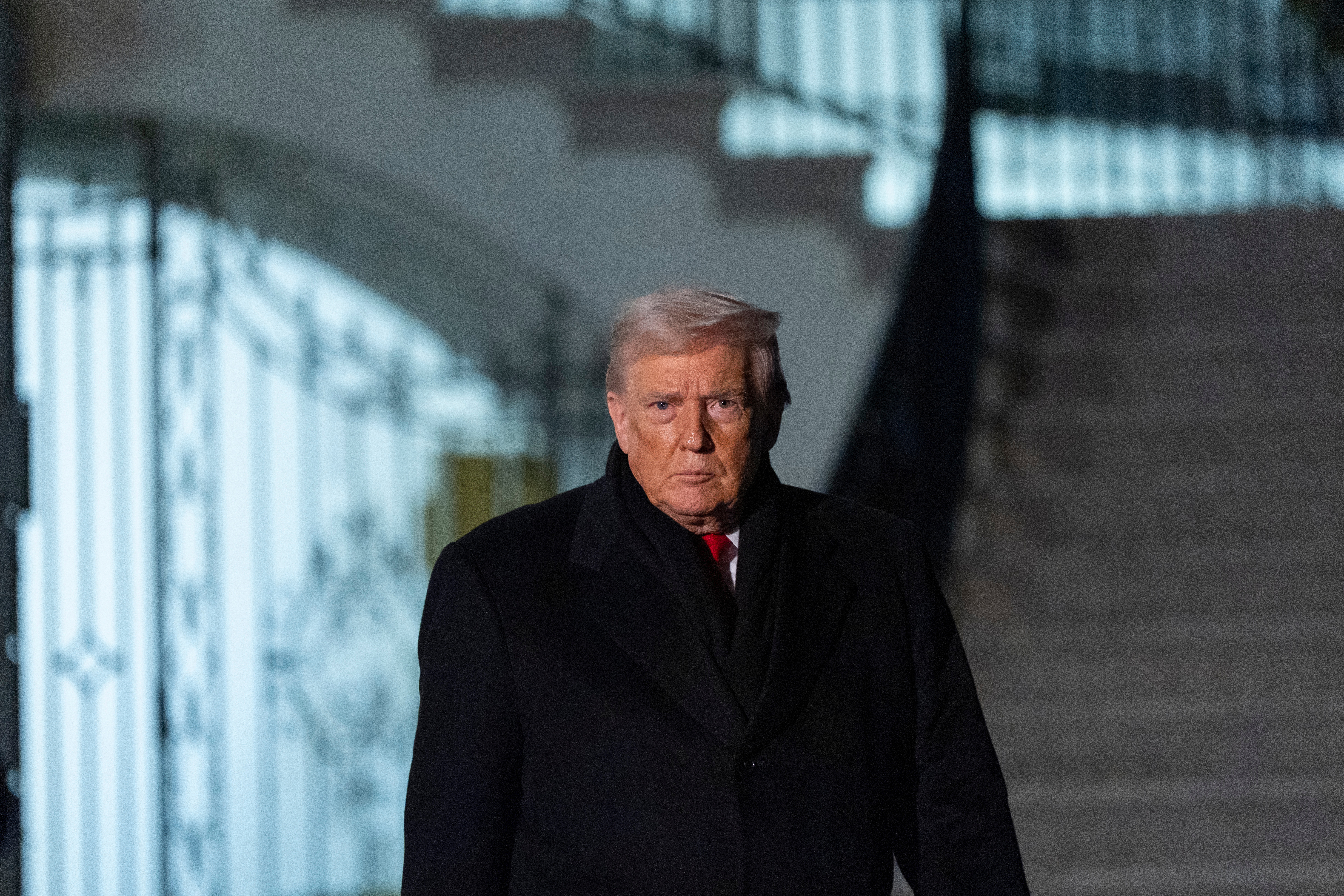 President Donald Trump walks speak with reporters before departing on Marine One from the South Lawn of the White House, Tuesday, Jan. 20, 2026, in Washington. (AP Photo/Alex Brandon)