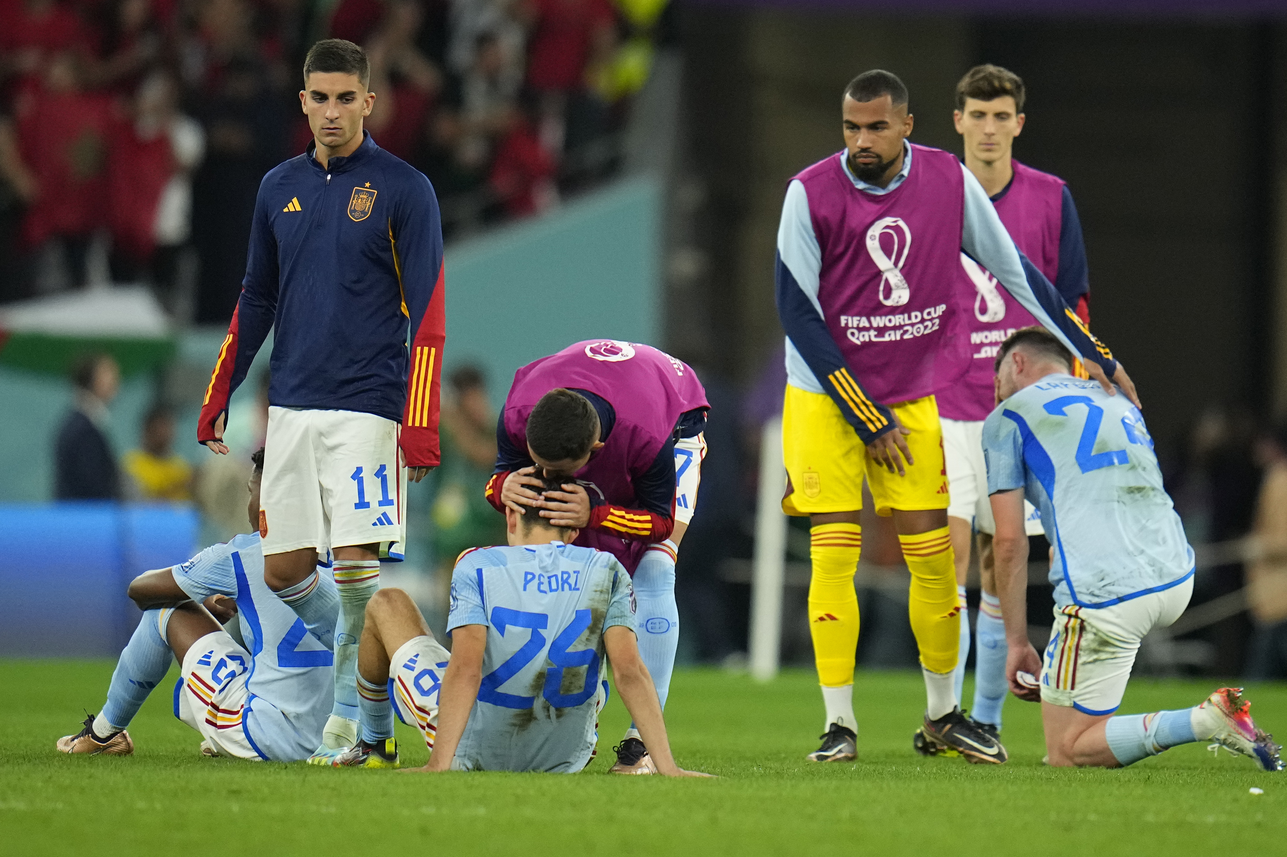Spain players react at the end of the World Cup round of 16 soccer match between Morocco and Spain, at the Education City Stadium in Al Rayyan, Qatar, Tuesday, Dec. 6, 2022. (AP Photo/Julio Cortez)