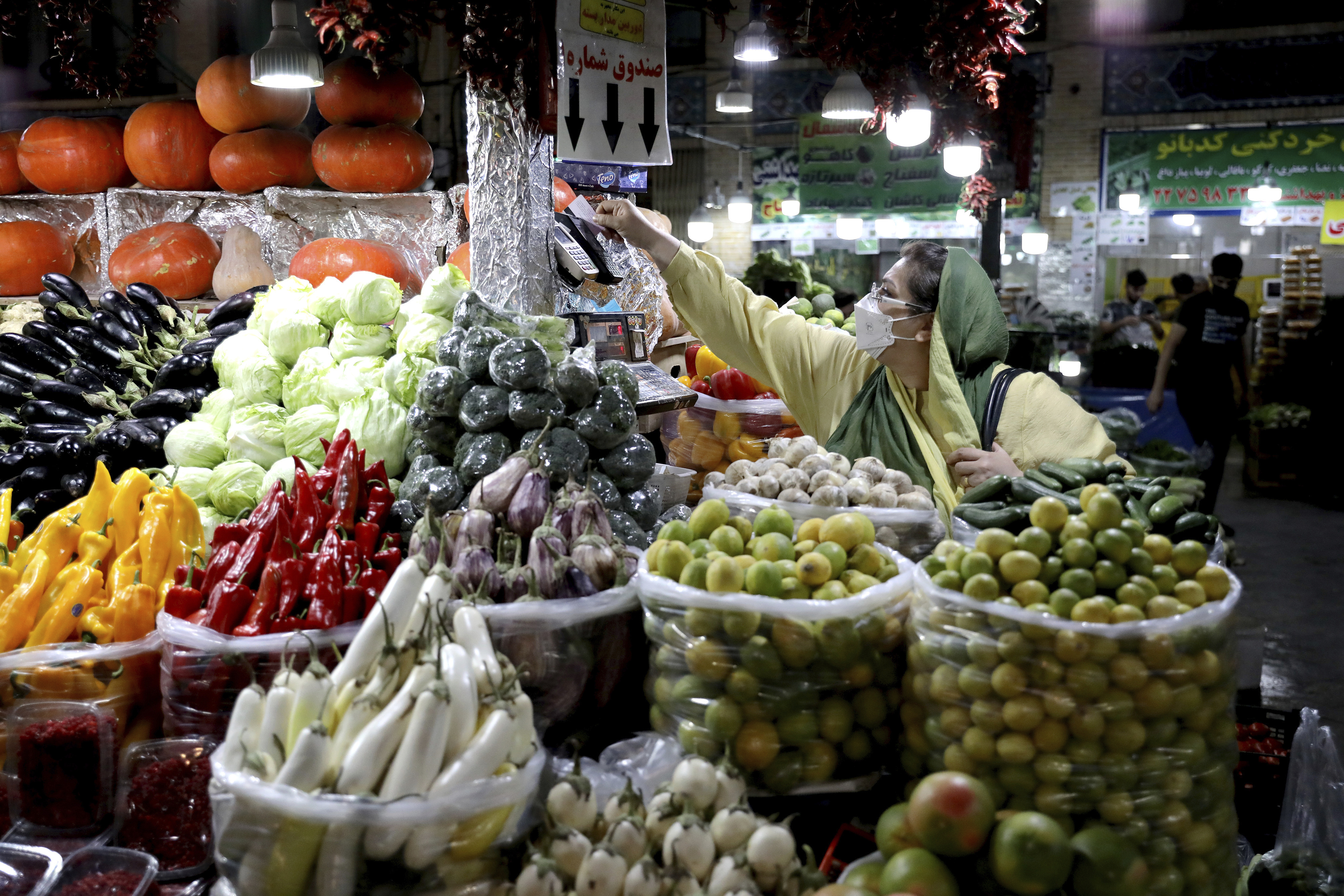 An Iranian woman shops in the Tajrish traditional bazaar in northern Tehran, Iran, Saturday, Sept. 25, 2021.