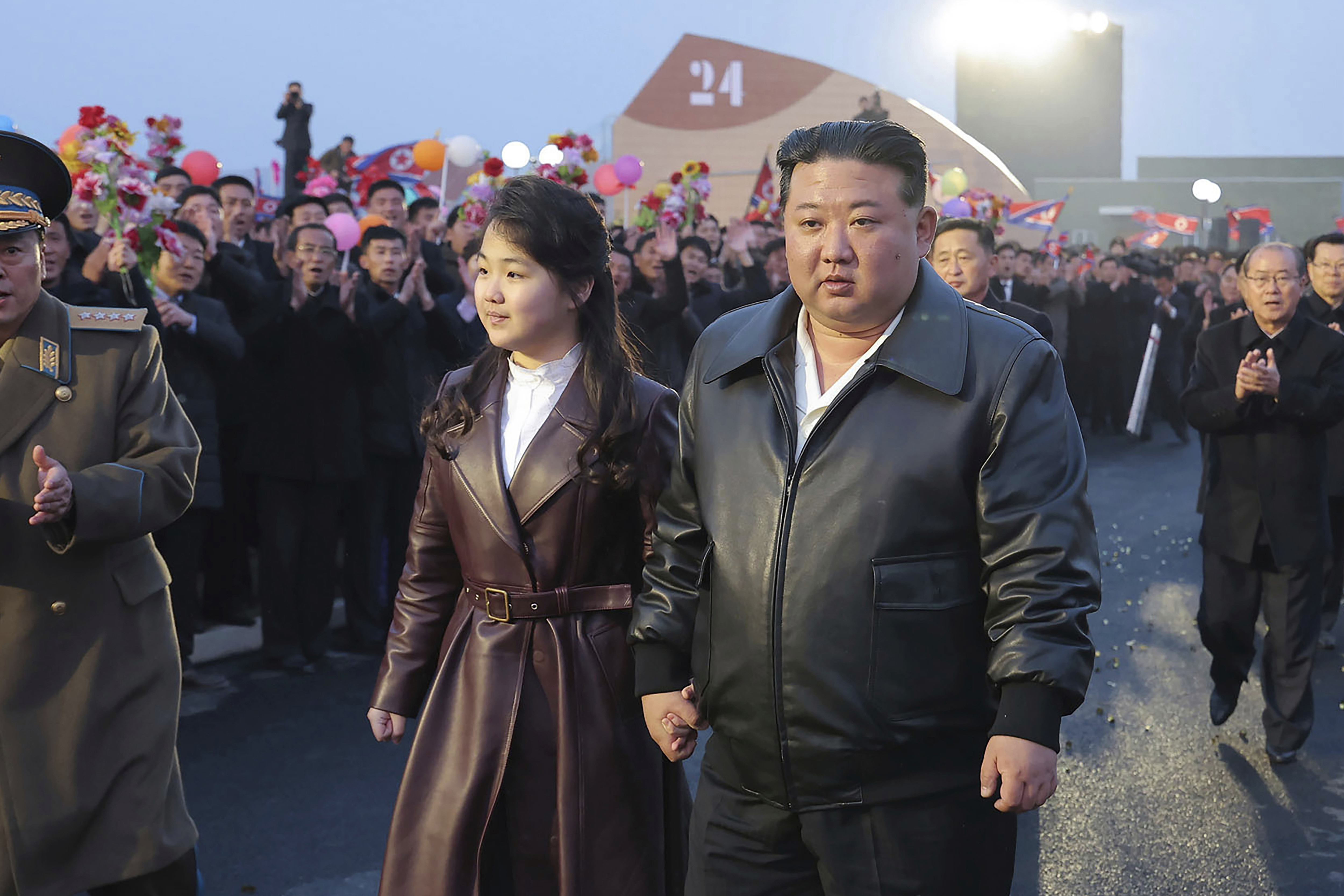 In this photo provided by the North Korean government, North Korean leader Kim Jong Un, center right, and his daughter attend a completion and operation ceremony of Kangdong Greenhouse Farm in Pyongyang, North Korea, March 15, 2024. 