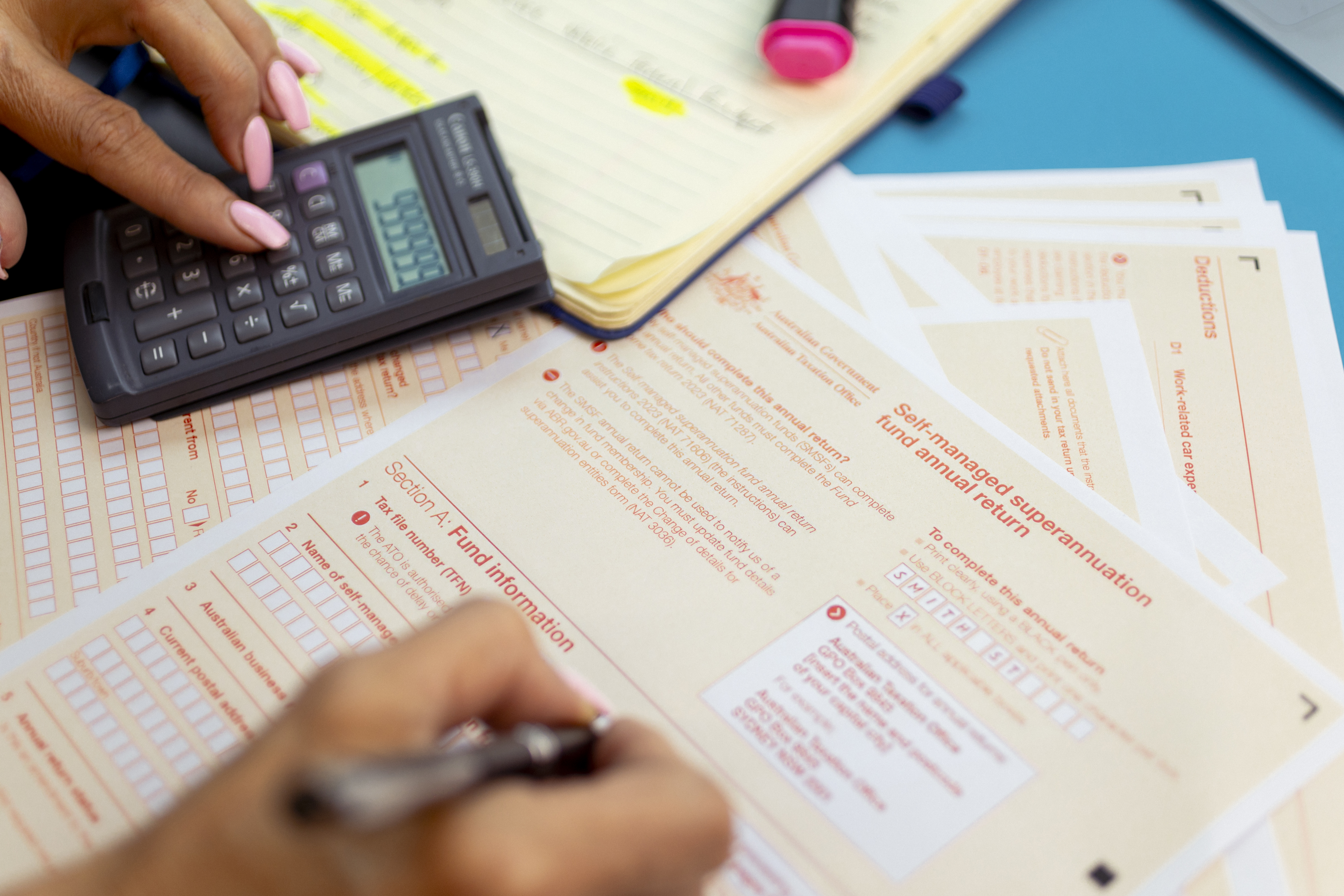 Generic picture of someone filling out a tax return.