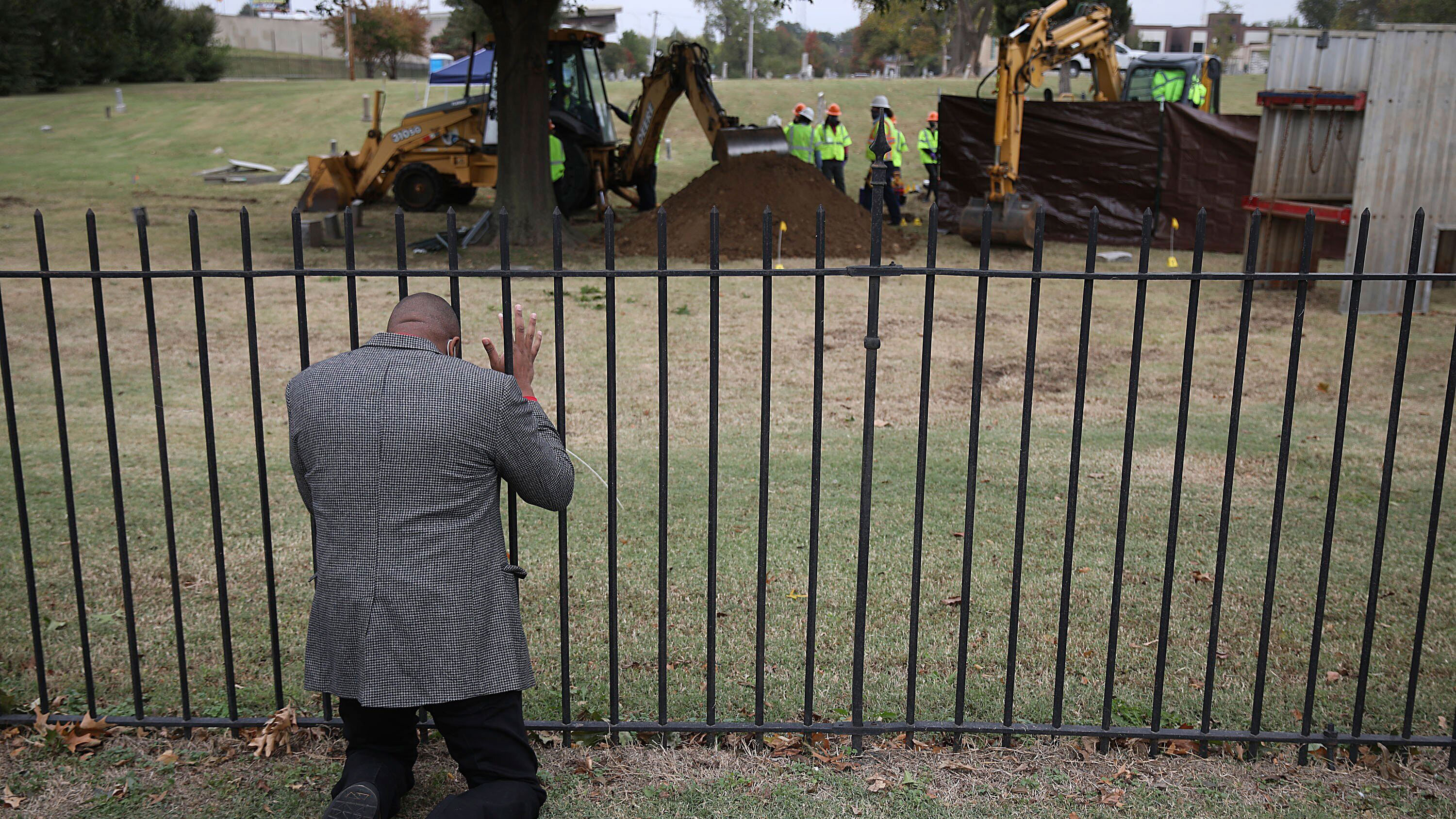 The Rev. Robert Turner prays as crews conduct a test excavation in October, 2020.