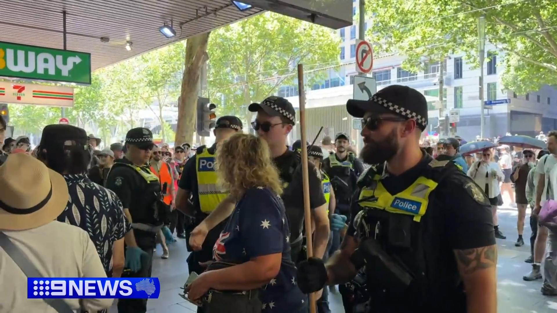 A woman was escorted from the Invasion Day march by police as they tried to minimise potential conflicts.