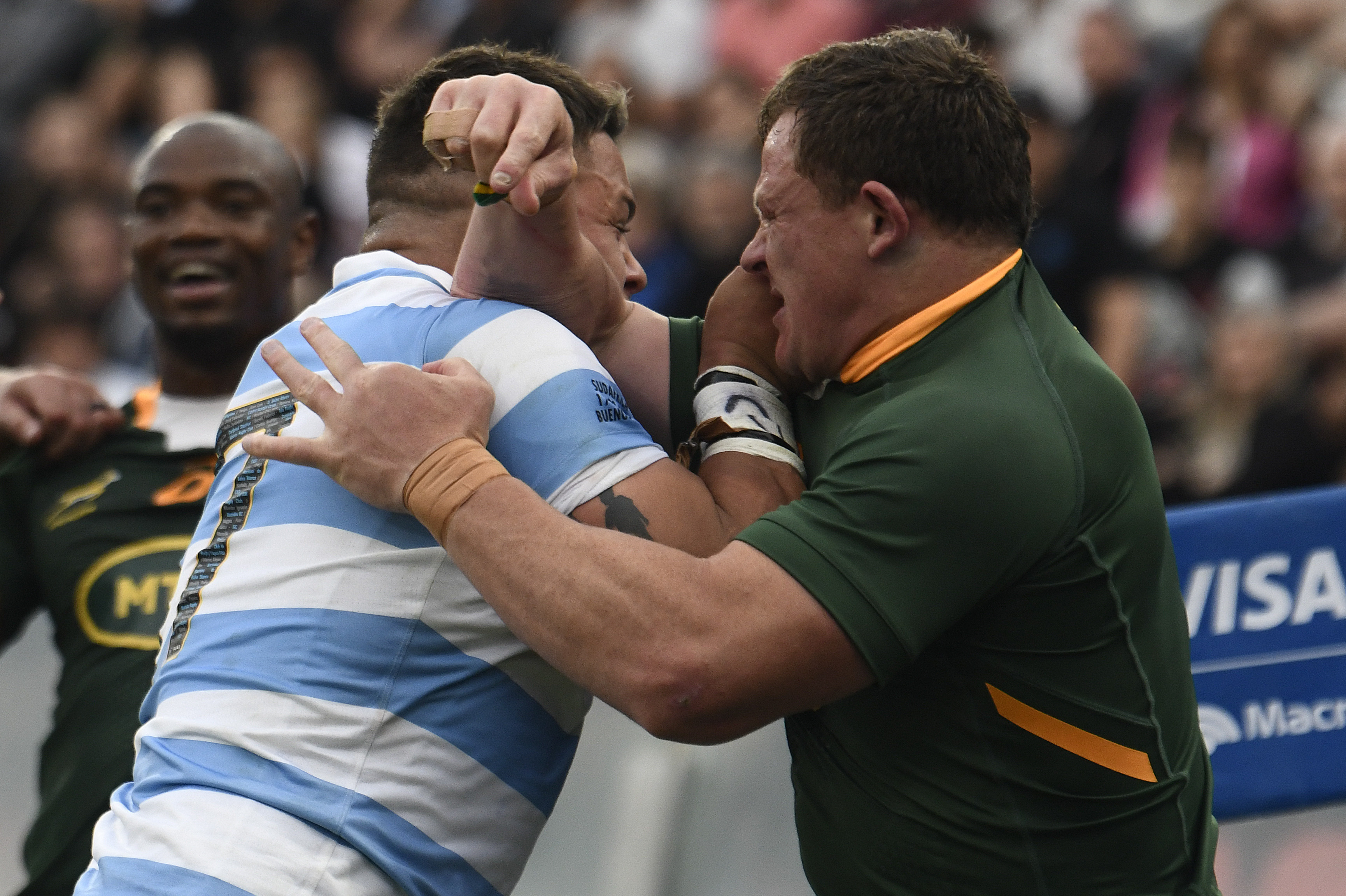 Argentina's Marcos Kremer and South Africa's Deon Fourie push each other.