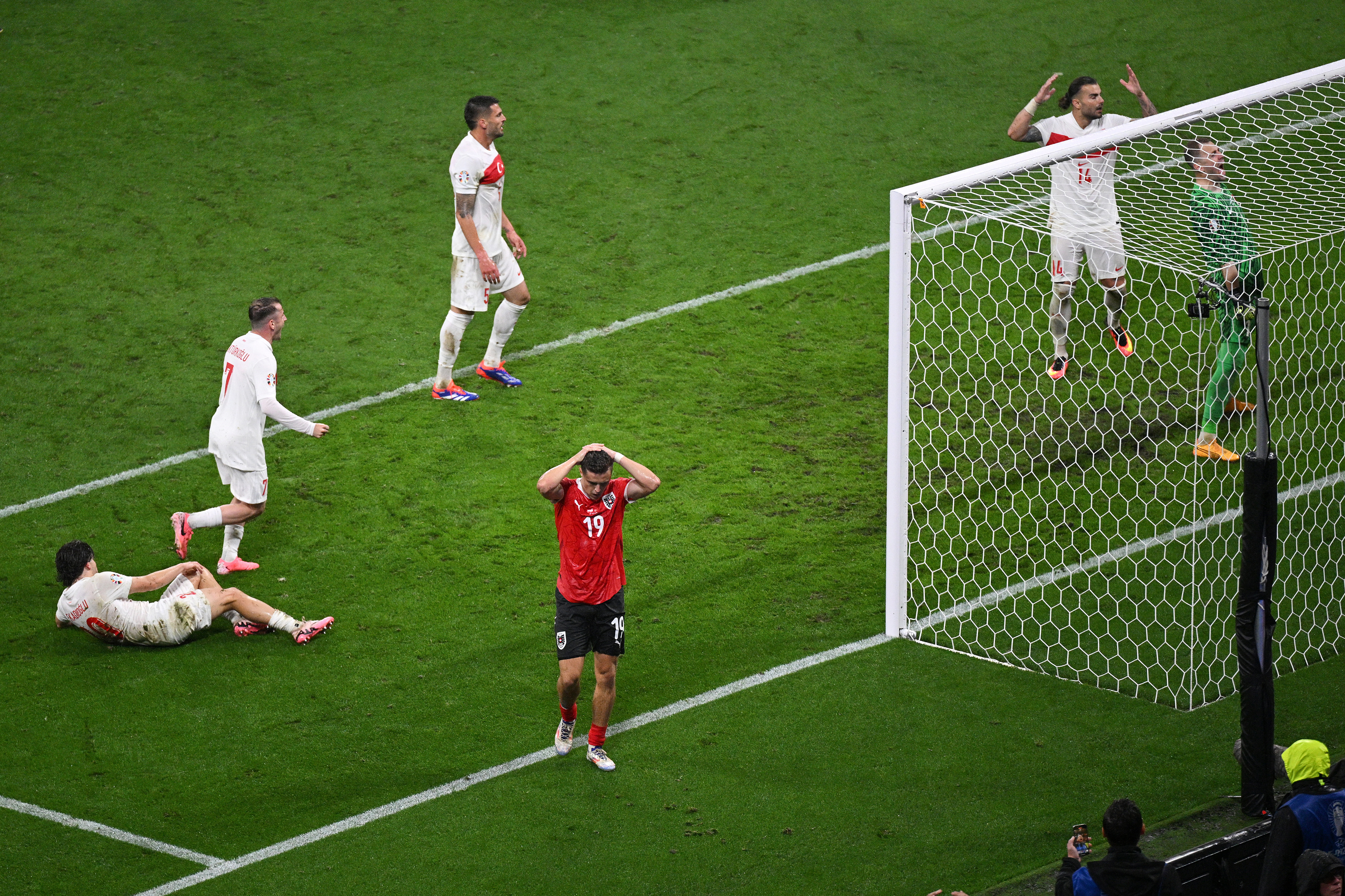 Christoph Baumgartner of Austria reacts after a missed chance as Mert Gunok of Turkey (obscured) celebrates.