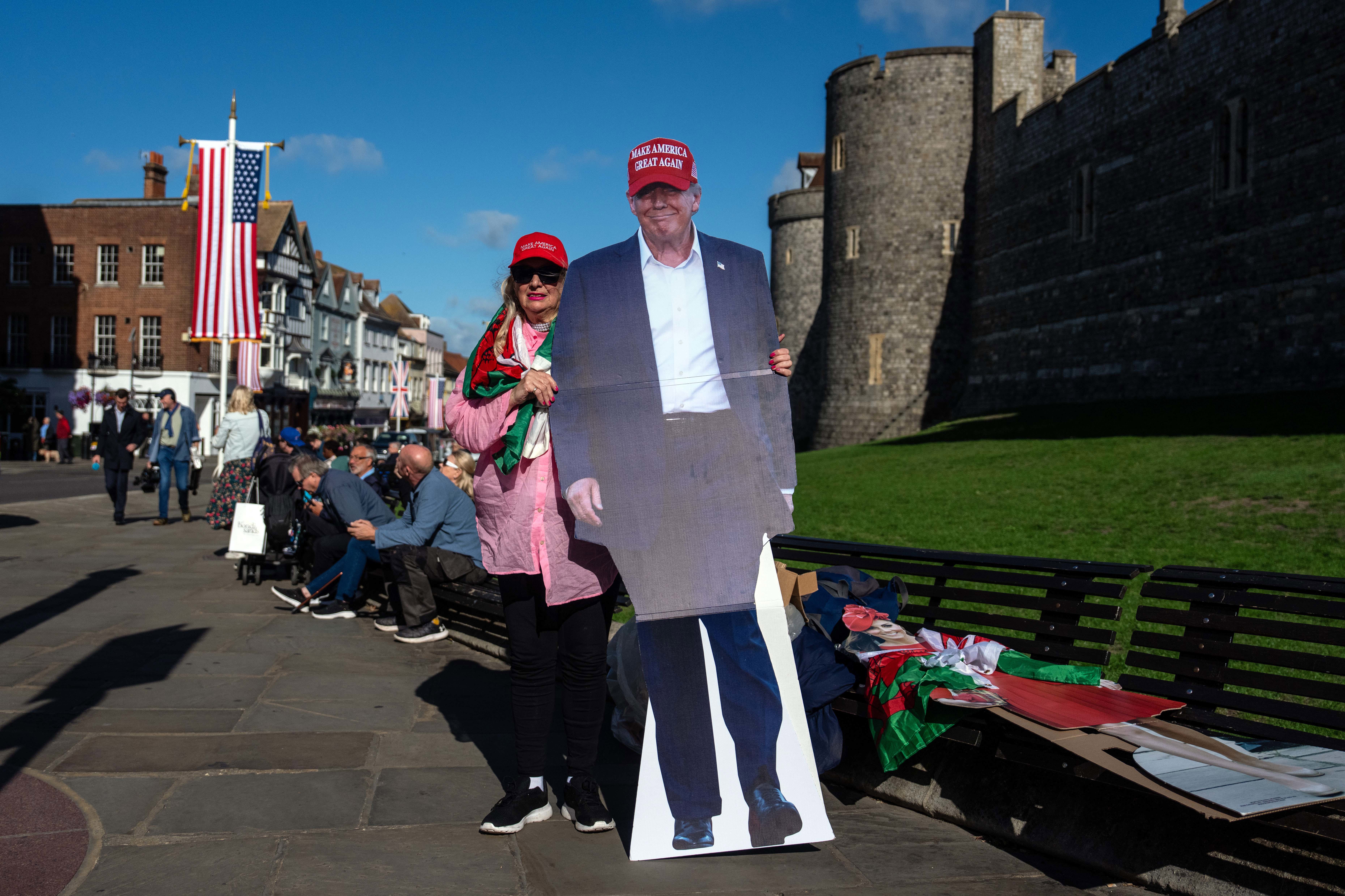A woman poses for a photograph with a life-sized cardboard cutout of U.S President Donald Trump 5 in Windsor.