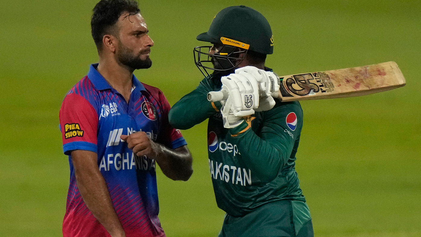 Afghanistan's Fareed Ahmad, left, and Pakistan's Asif Ali, right, react after Ali was dismissed in their Asian Cup match.