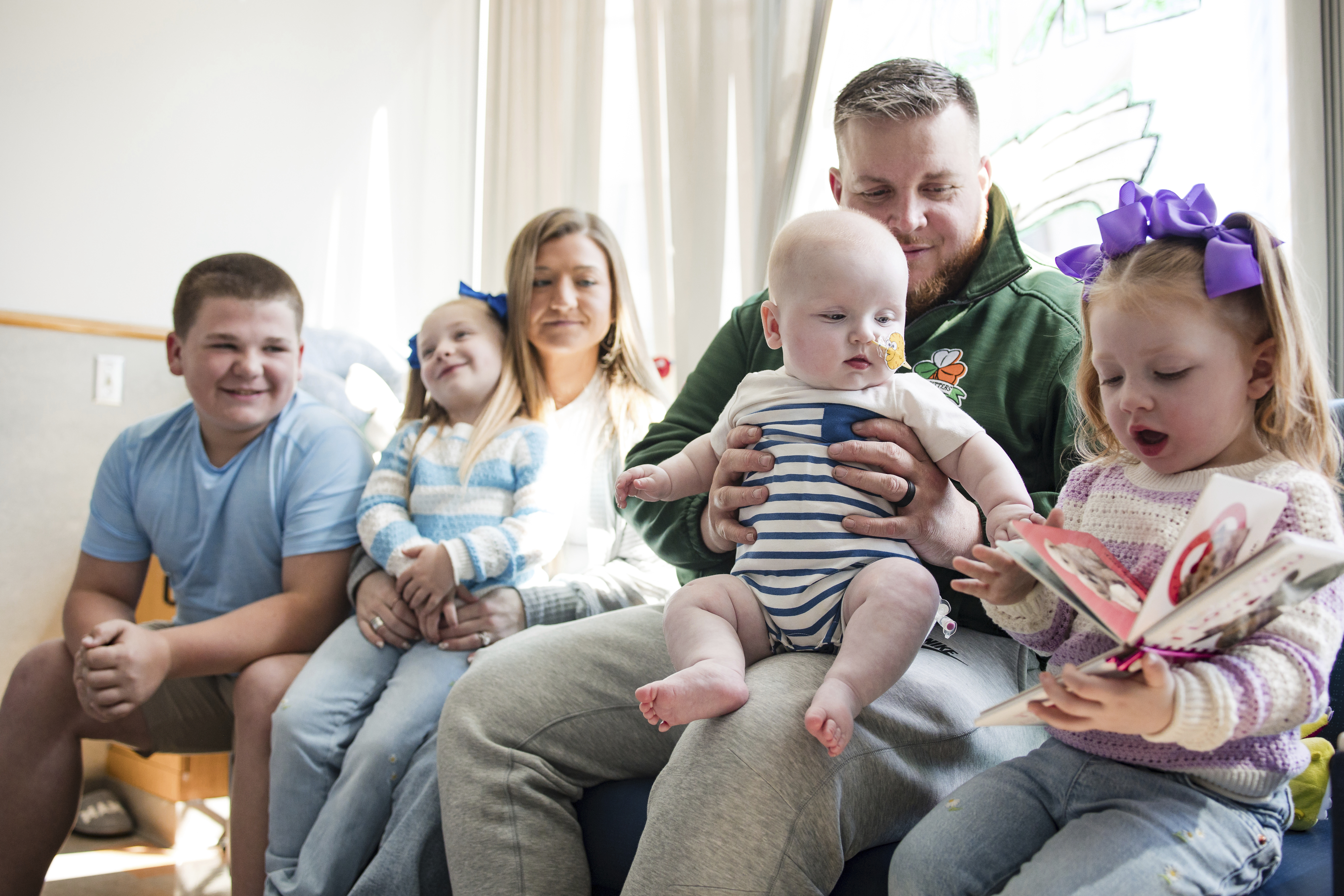 In this photo provided by the Children's Hospital of Philadelphia, KJ Muldoon sits with his parents, Kyle and Nicole Muldoon, and his siblings after a follow up dose of an experimental gene editing treatment at the hospital in April 2025. 
