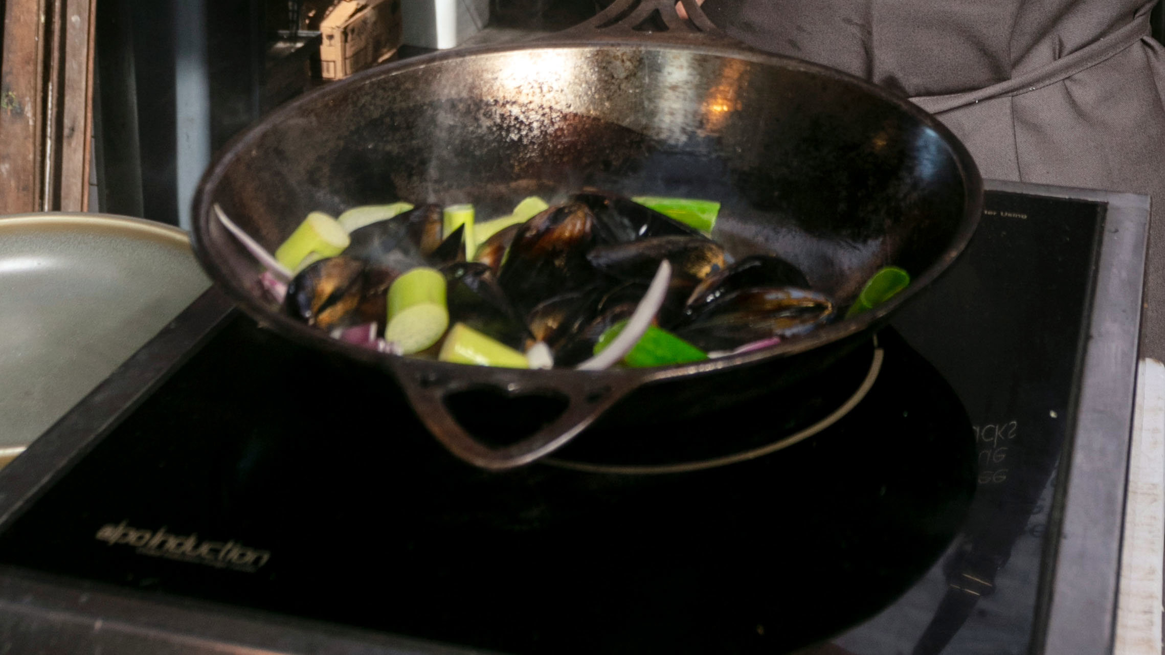 An induction cooktop with a pan on it