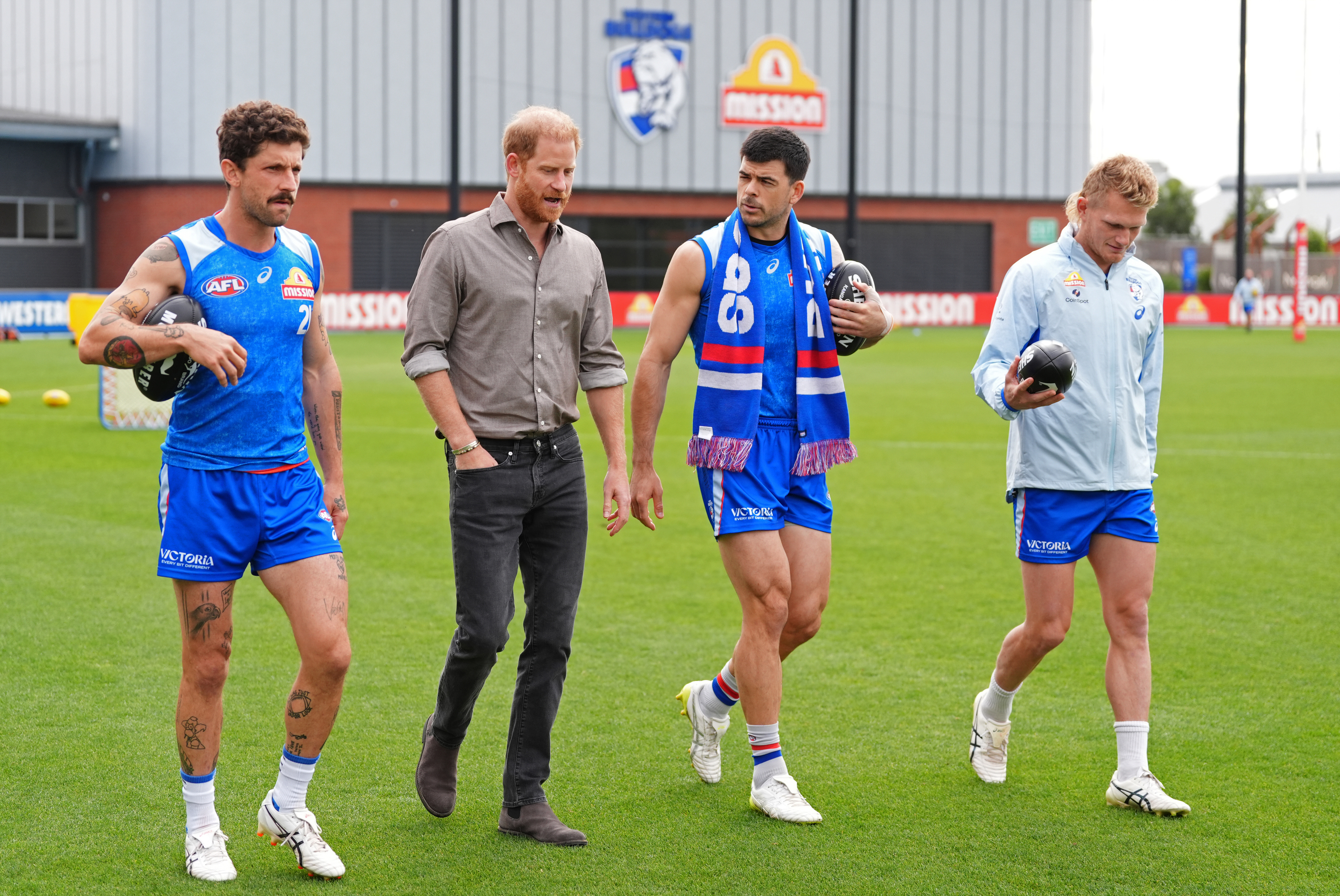Prince Harry, center left, The Duke of Sussex, meets Western Bulldogs players during a visit to Movember at the Western Bulldogs HQ at Mission Whitten Oval, in Footscray, a suburb of Melbourne, Australia Wednesday, April 15, 2026. (Jonathan Brady/Pool Photo via AP)