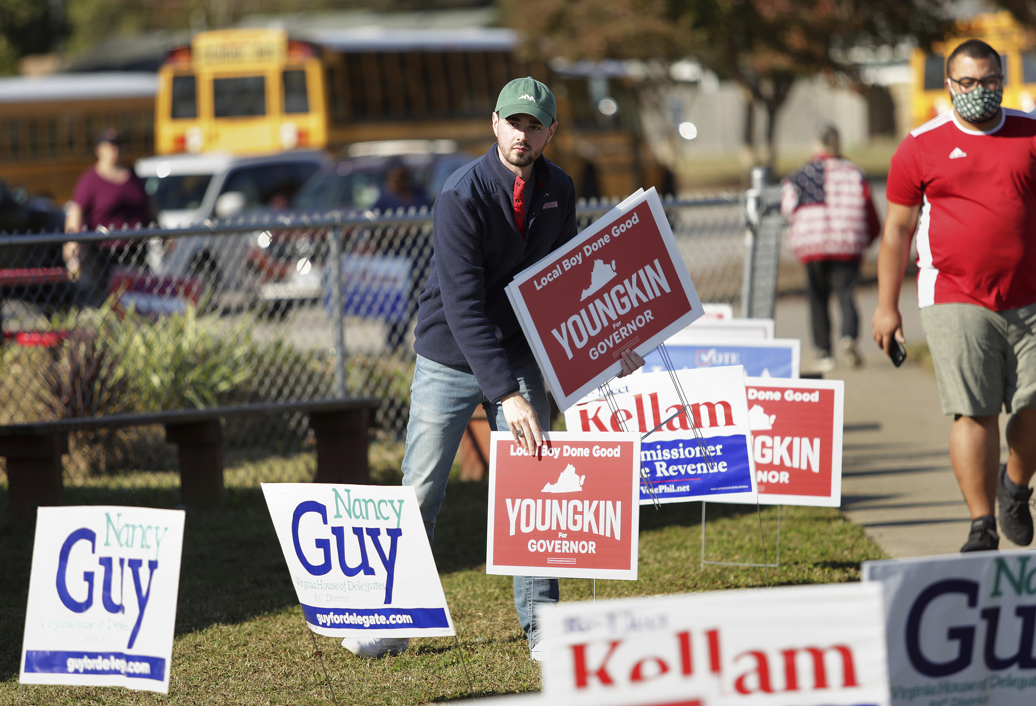 Last minute signs of support are placed for gubernatorial candidate Glenn Youngkin at the Bayside Sixth Grade Campus. 