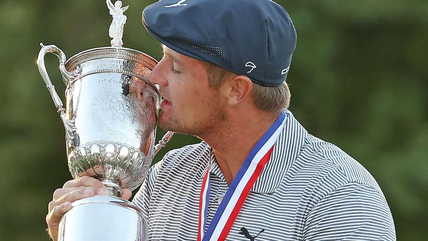 Bryson DeChambeau of the United States kisses the championship trophy