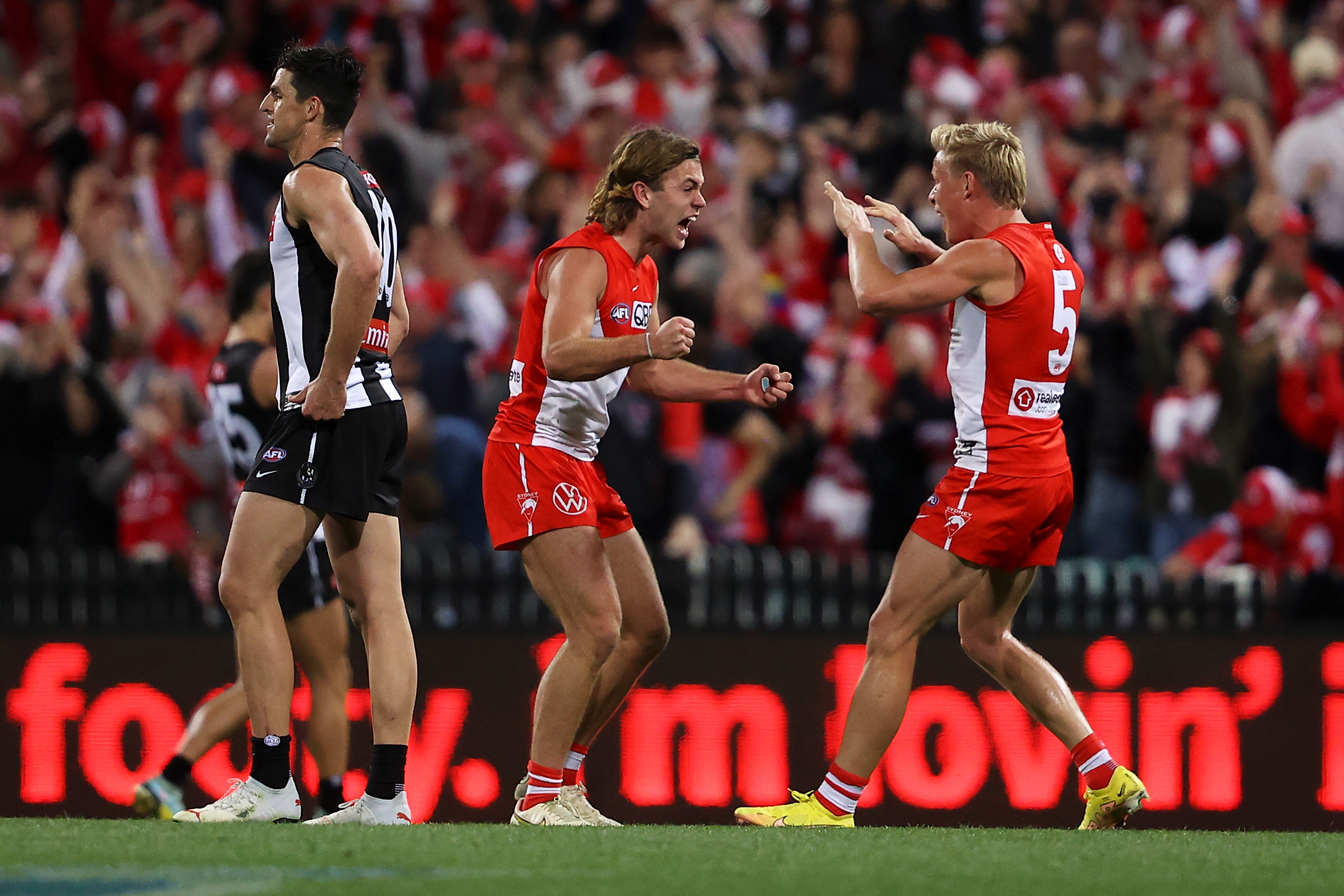 James Rowbottom and Isaac Heeney of the Swans celebrate victory over the Magpies.