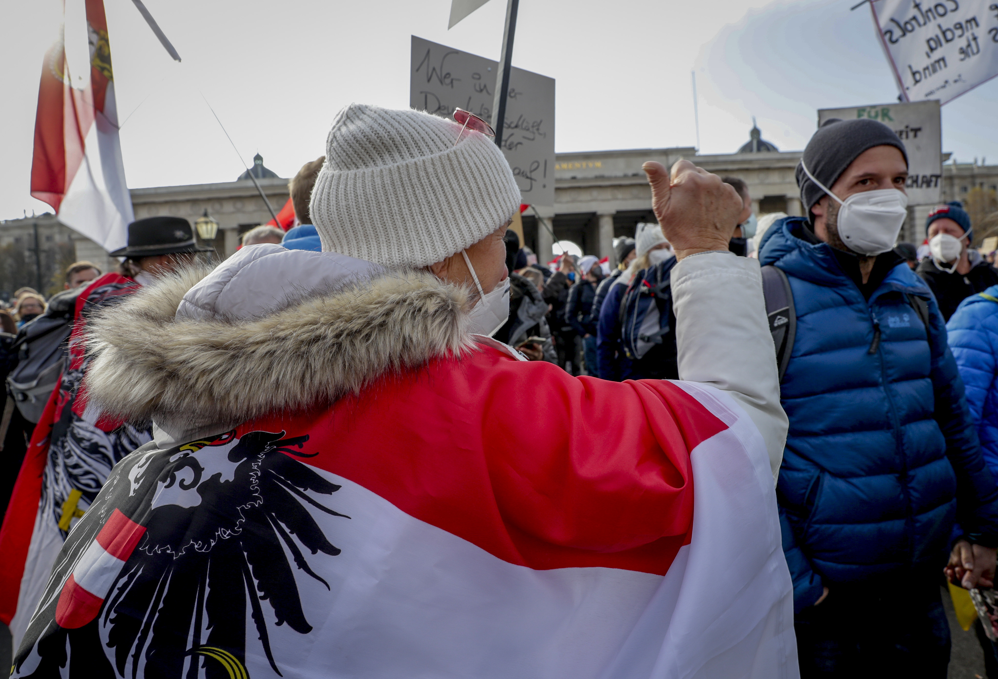 People take part in a demonstration against the country's coronavirus restrictions in Vienna, Austria