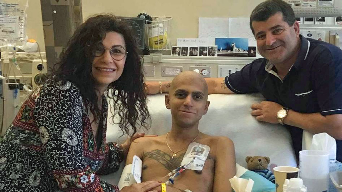 Mr Sylo, pictured with his parents in hospital in the US.