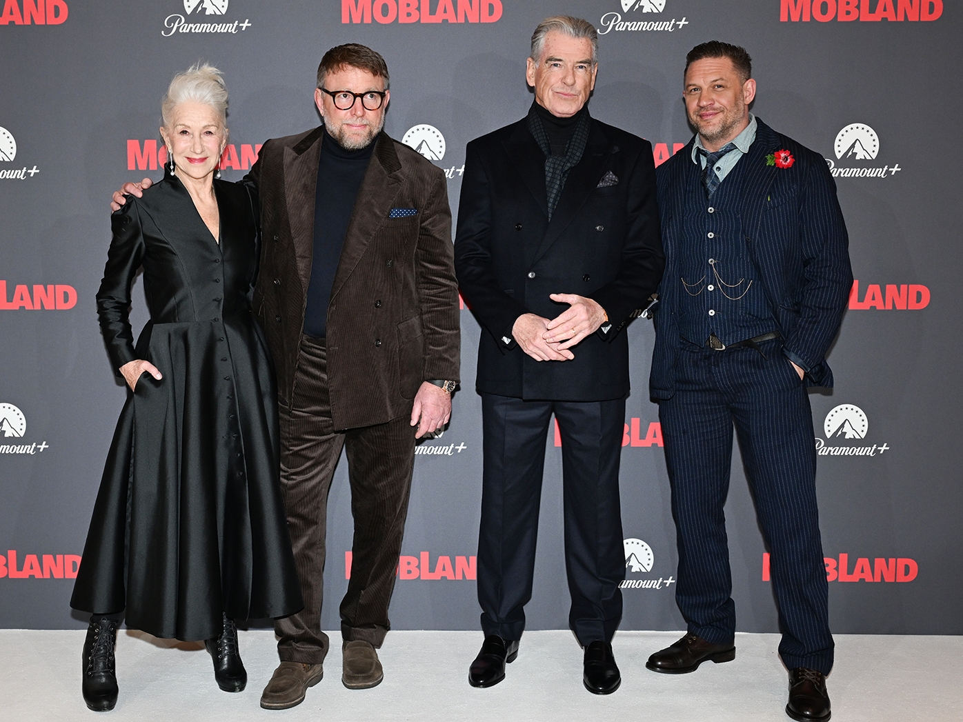 Dame Helen Mirren, Guy Ritchie, Pierce Brosnan and Tom Hardy at the Global Premiere of MobLand at Odeon Luxe Leicester Square on March 27, 2025 in London, England.