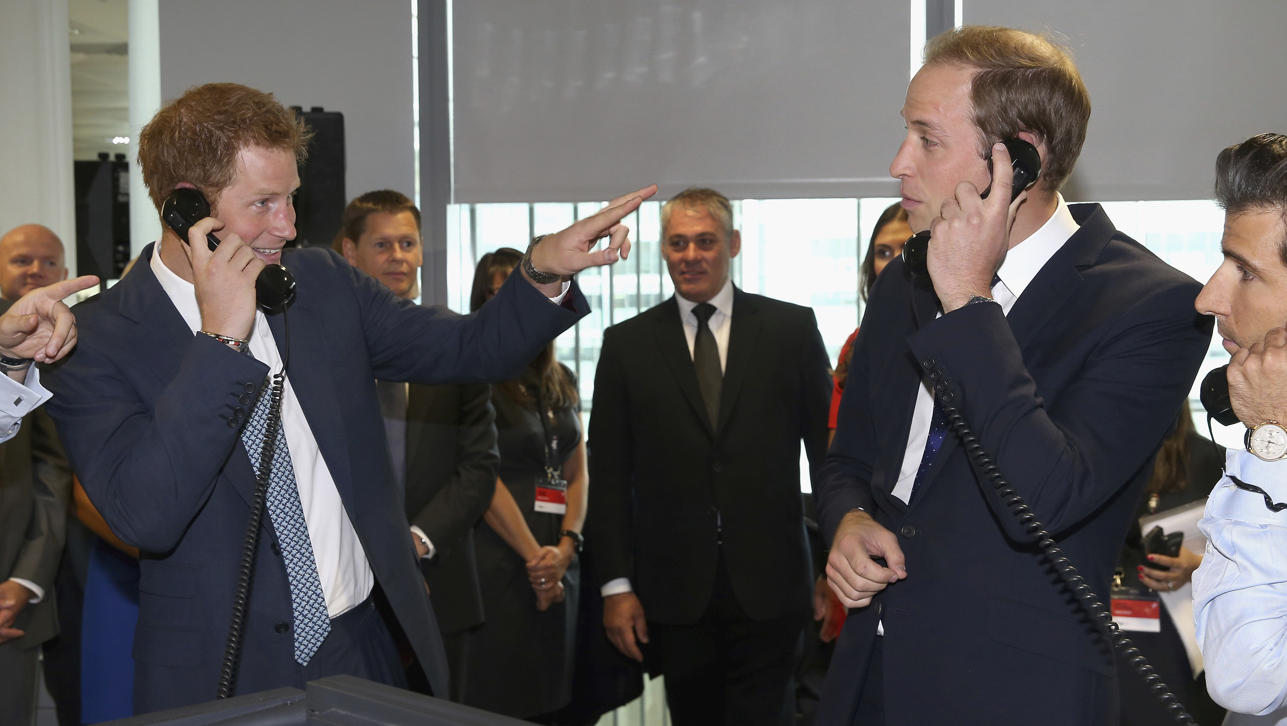 Prince William, Duke of Cambridge, right and his brother Prince Harry take part in a trade on the BGC Partners trading floor, during the BGC Charity Day 2013, in Canary Wharf, London, Wednesday, Sept. 11, 2013.